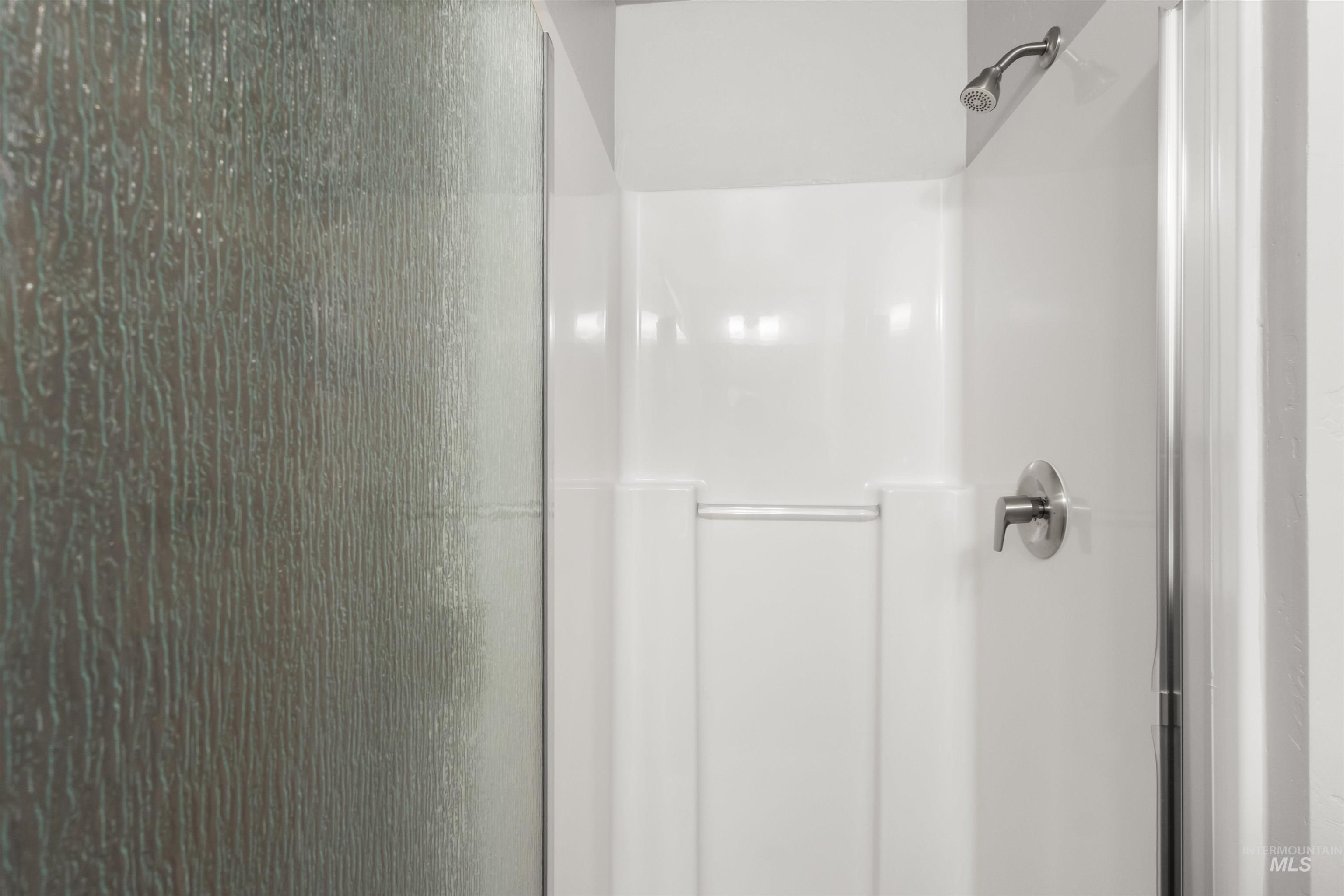 Full bathroom on main floor with a shower stall