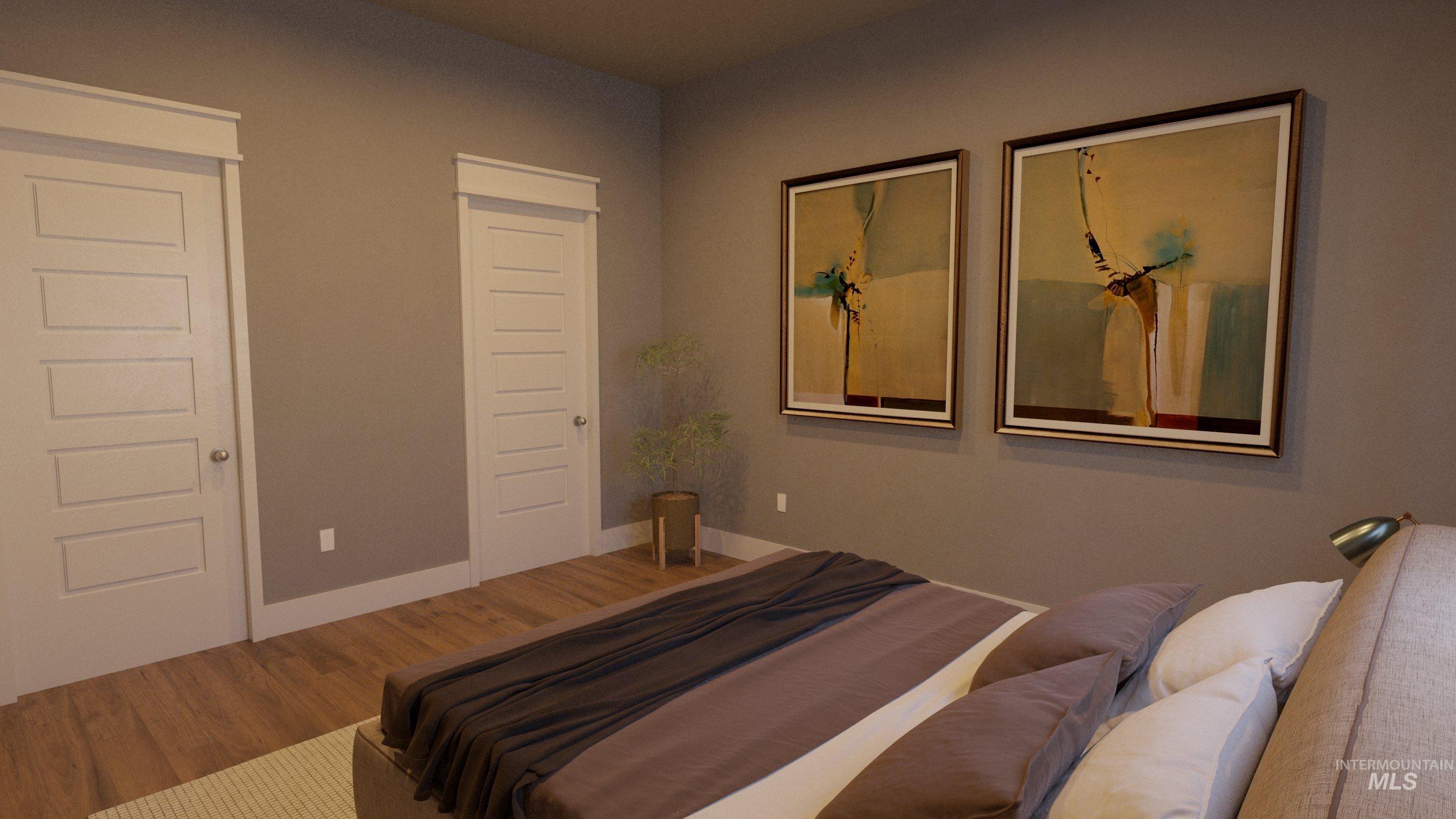 Bedroom with wood finished floors and baseboards