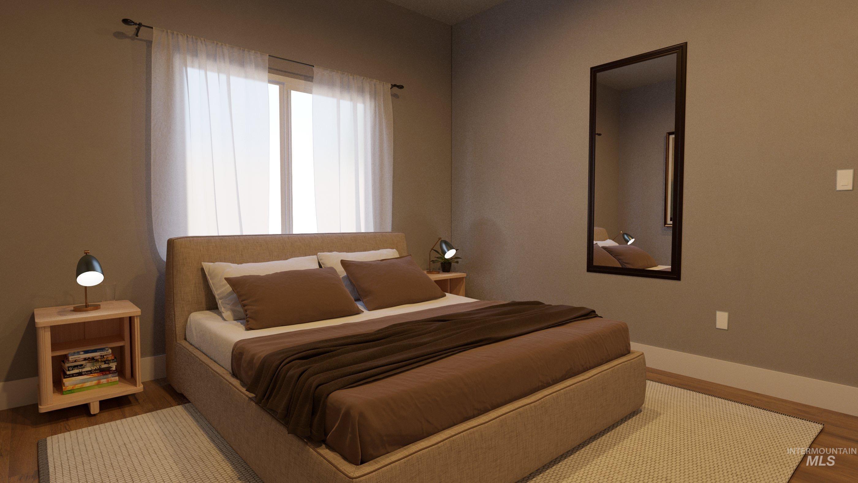 Bedroom featuring wood finished floors and baseboards