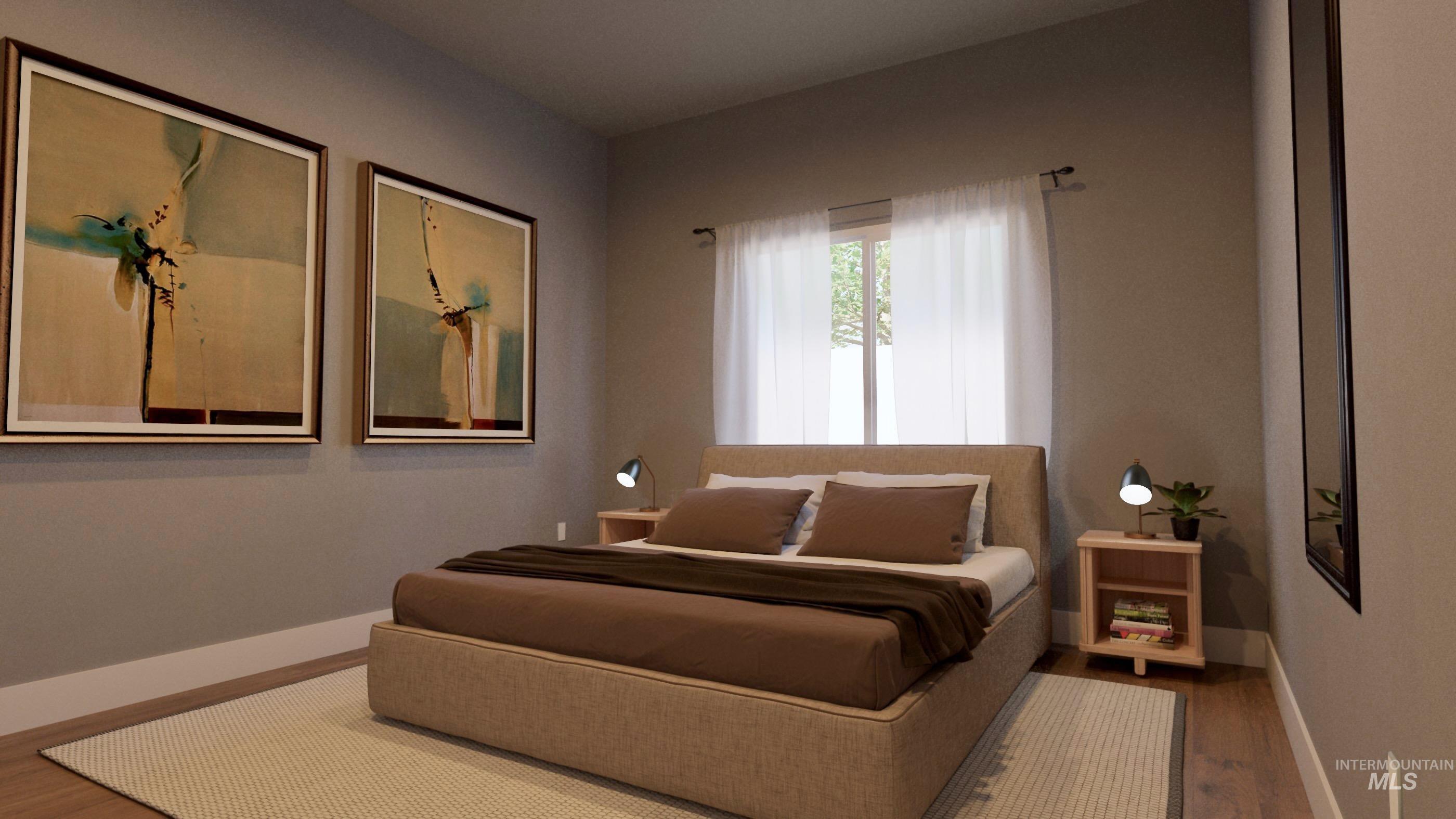 Bedroom featuring wood finished floors and baseboards