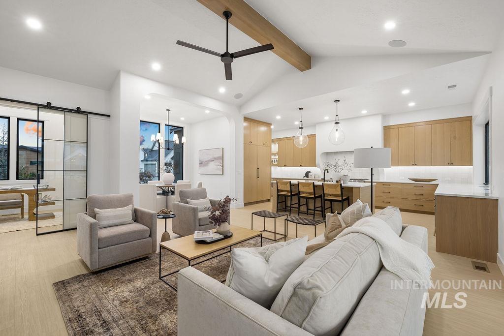 Living area featuring a ceiling fan, light wood-style flooring, recessed lighting, and a barn door