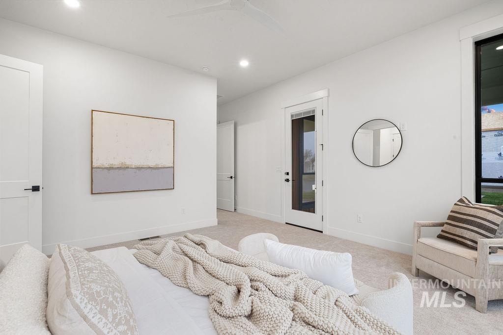 Carpeted bedroom with recessed lighting, ceiling fan, and access to exterior