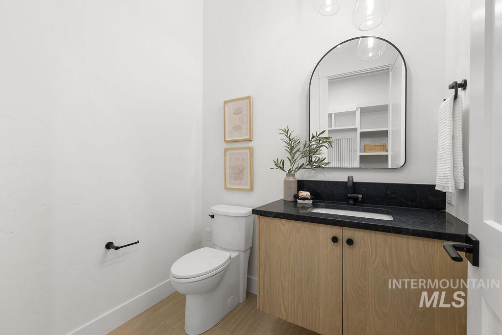 Half bathroom with vanity and light wood finished floors