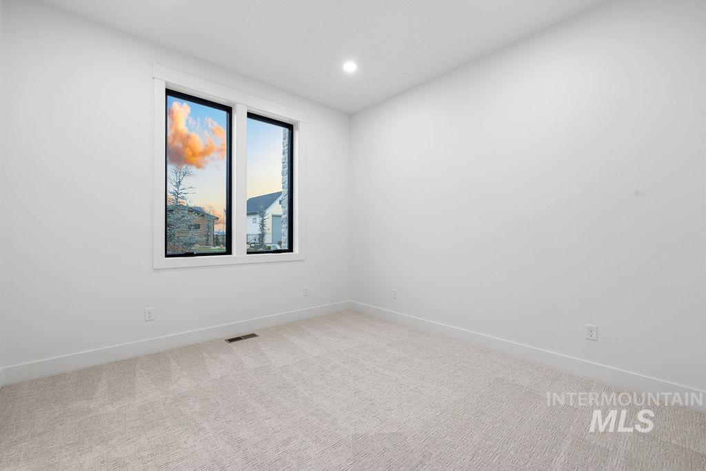 Spare room with light carpet and recessed lighting