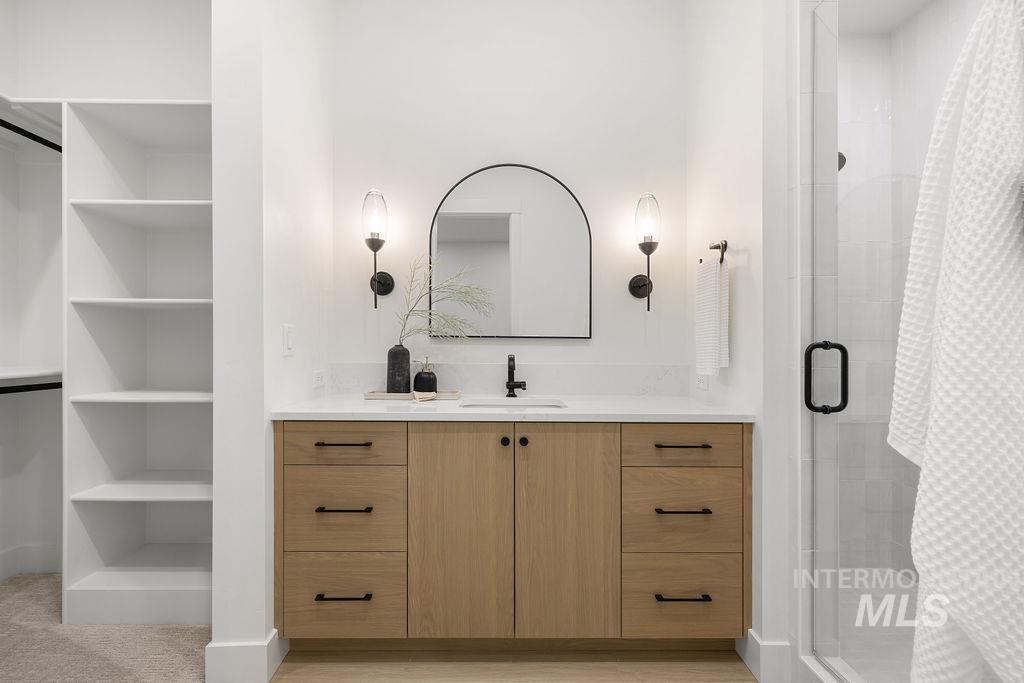 Bathroom with vanity and a stall shower