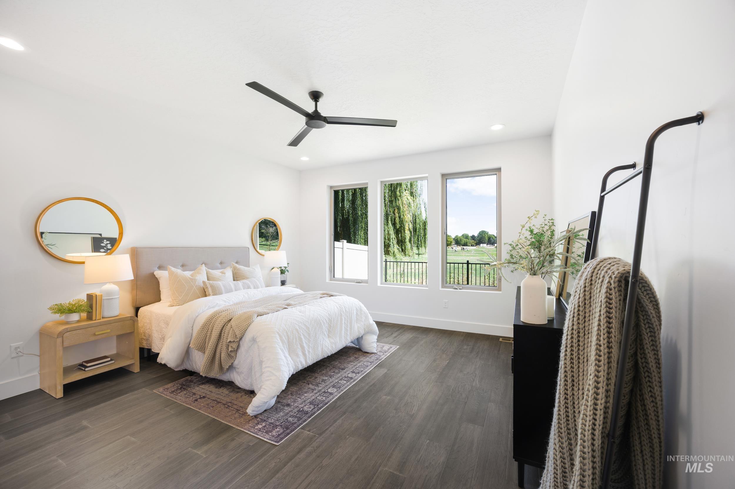 Bedroom with dark wood finished floors, ceiling fan, and recessed lighting