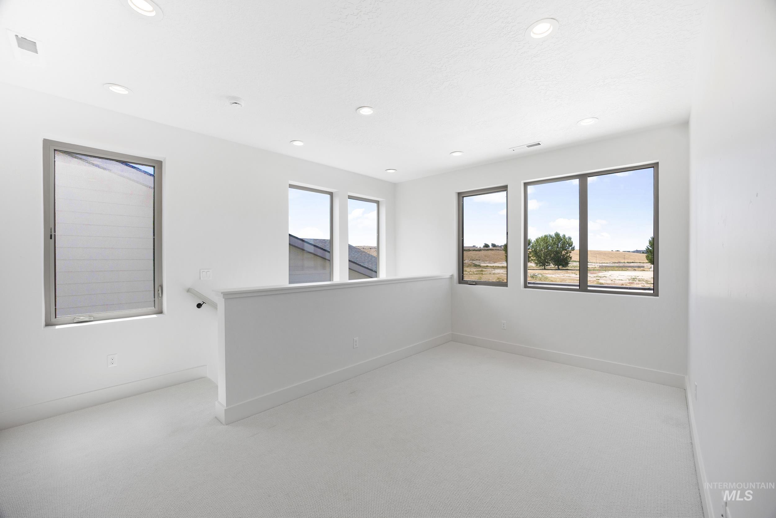 Unfurnished room featuring light colored carpet and recessed lighting