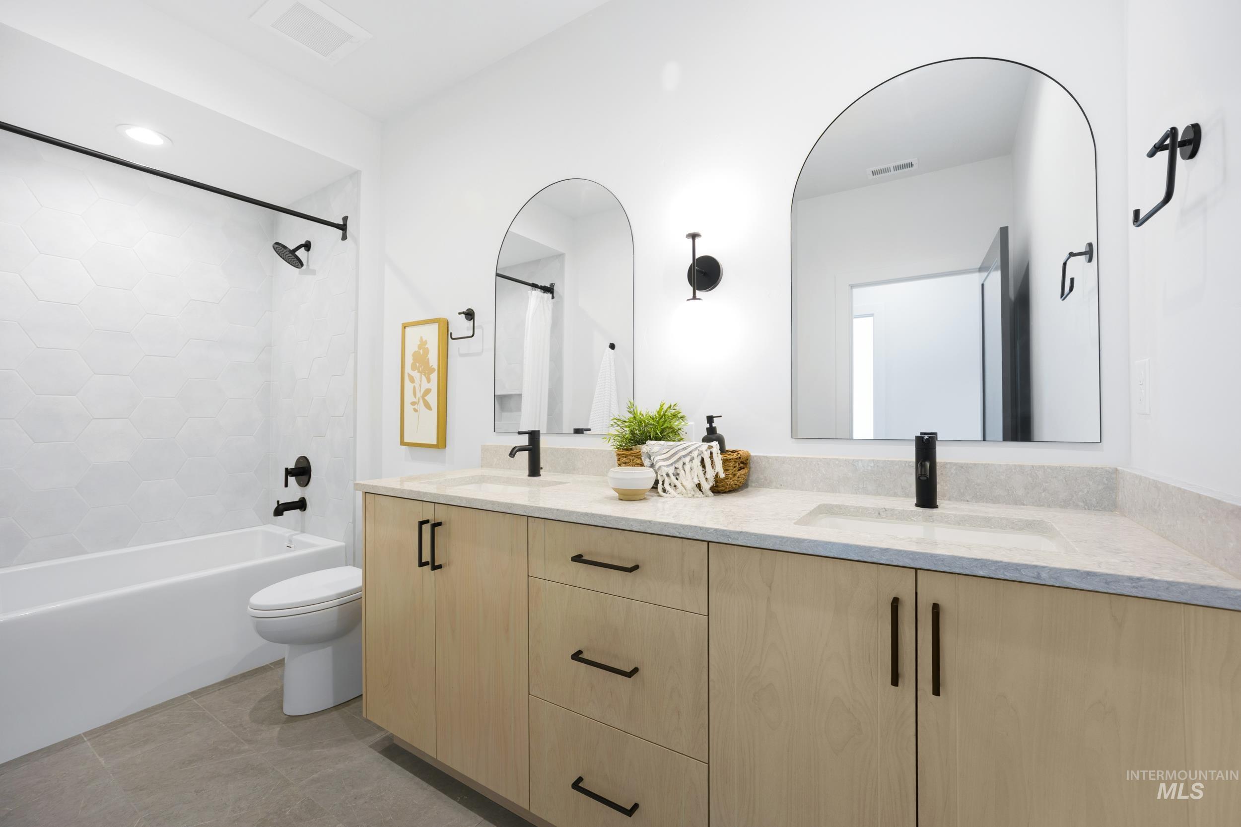 Bathroom with shower / bath combination with curtain, double vanity, light tile patterned floors, and recessed lighting