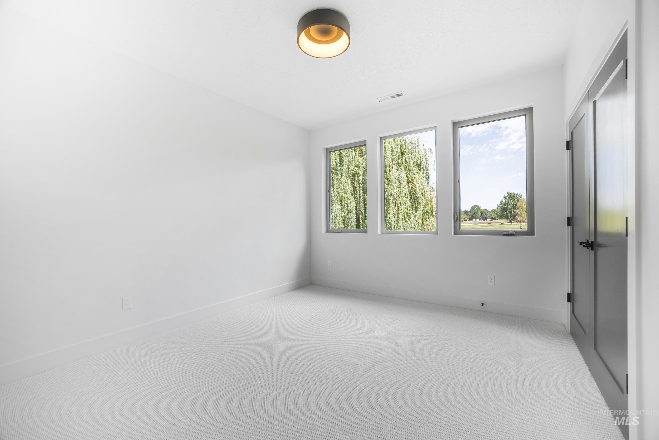 Unfurnished room with light carpet and baseboards