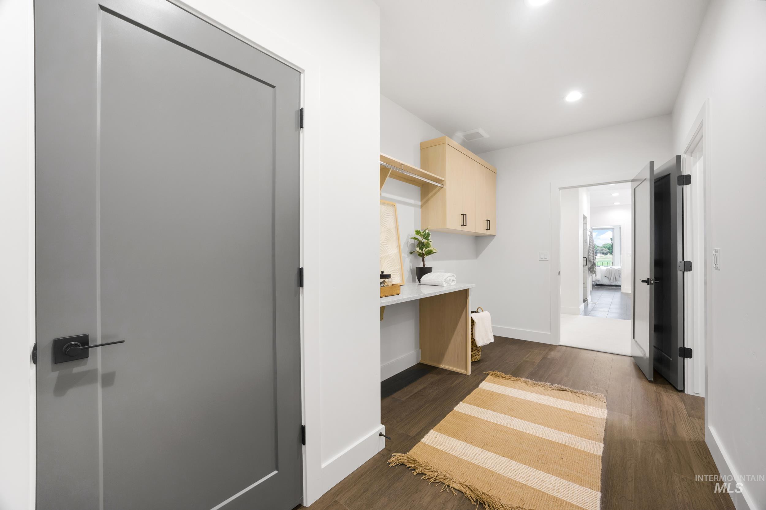 Kitchen featuring light brown cabinetry, dark wood-style flooring, recessed lighting, and light countertops