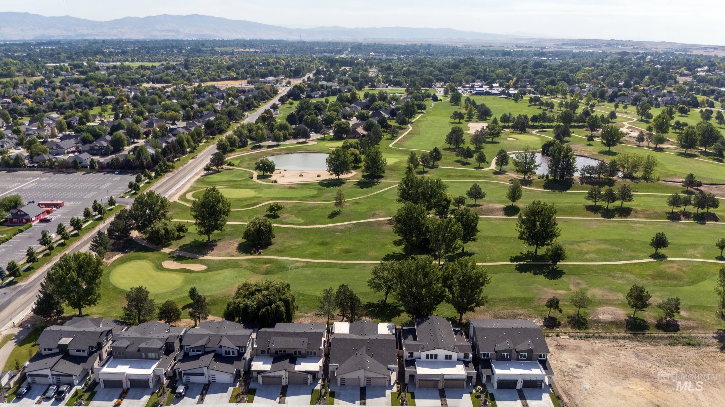Aerial view of property's location featuring nearby suburban area and a water and mountain view