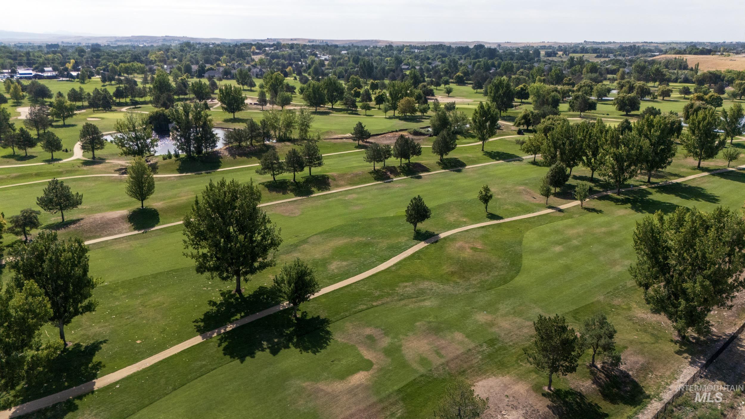 Bird's eye view of a large body of water and a local golf course