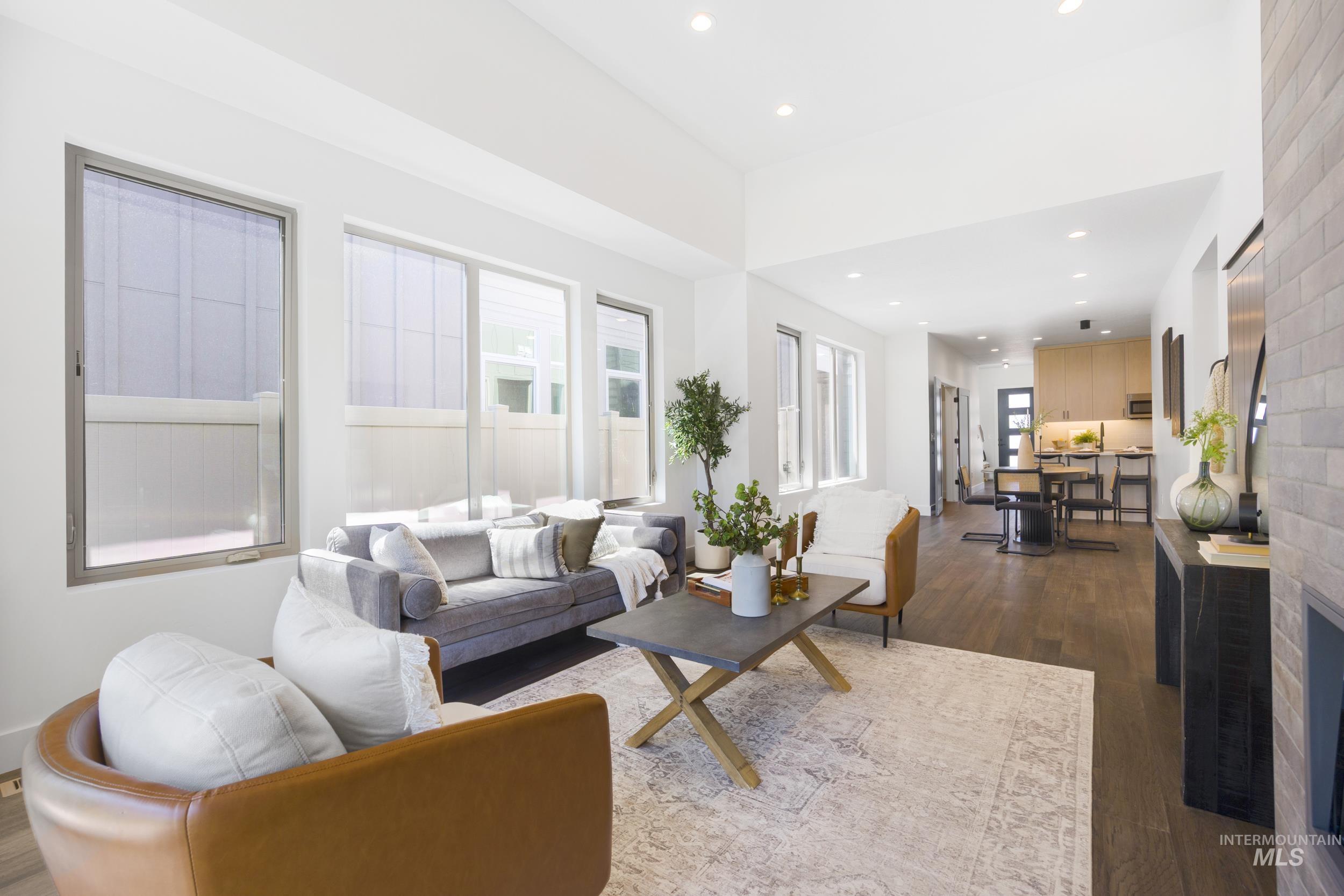 Living area featuring dark wood finished floors and recessed lighting