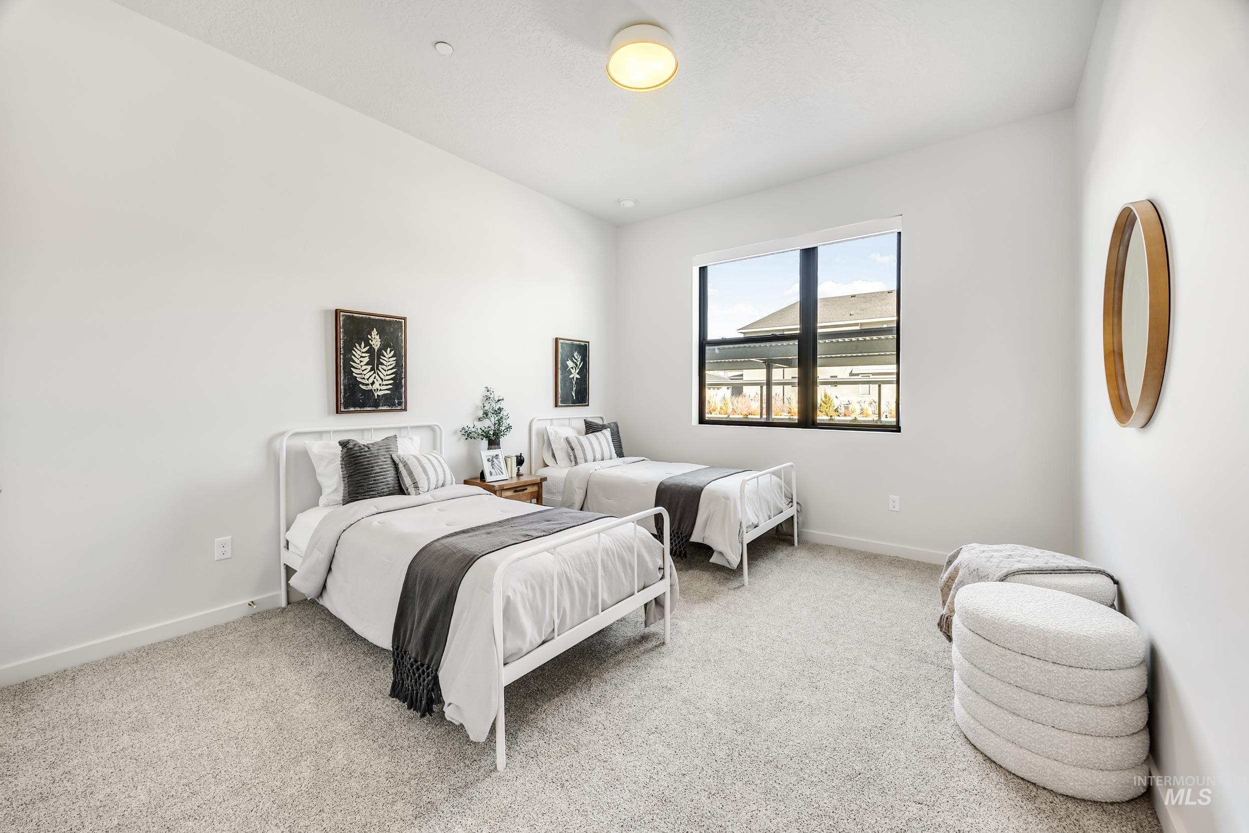 Bedroom featuring light carpet and baseboards