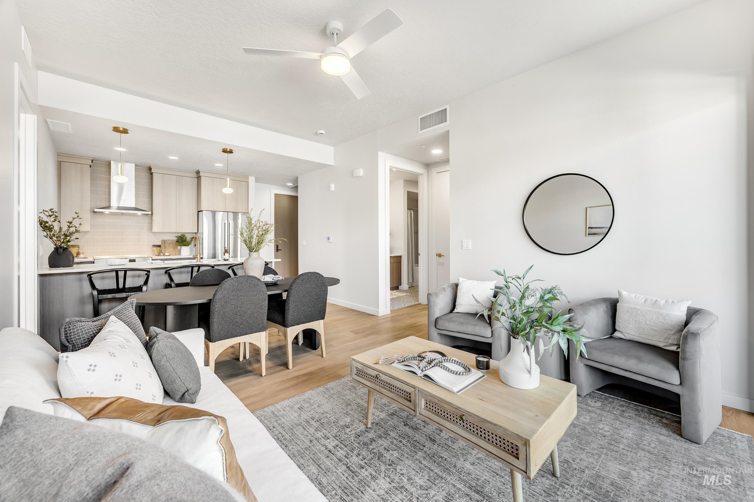 Living area with light wood-style flooring, a ceiling fan, and recessed lighting