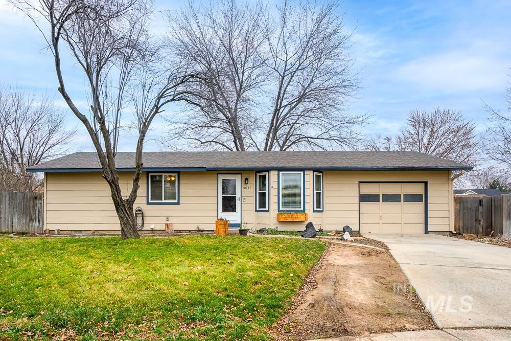 Single story home with a garage and concrete driveway