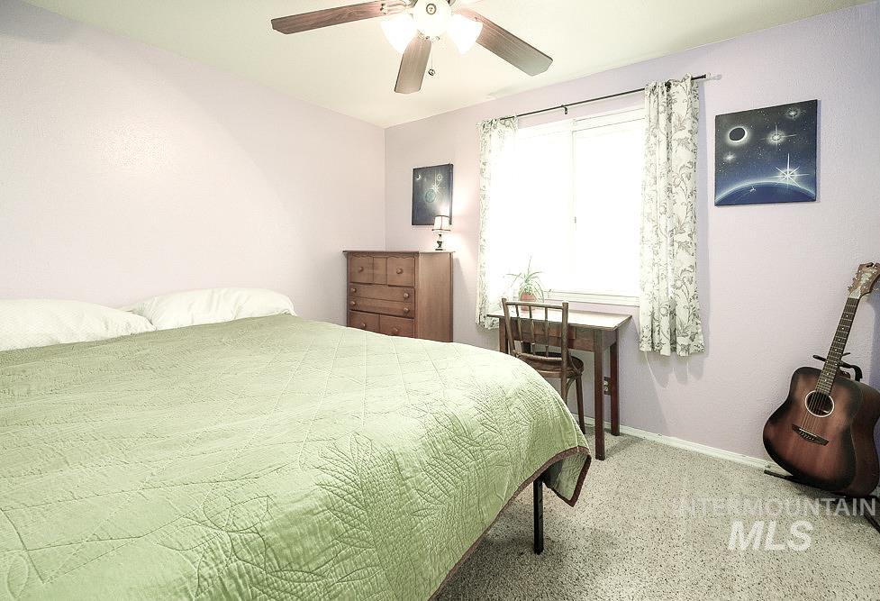Bedroom featuring a ceiling fan and baseboards