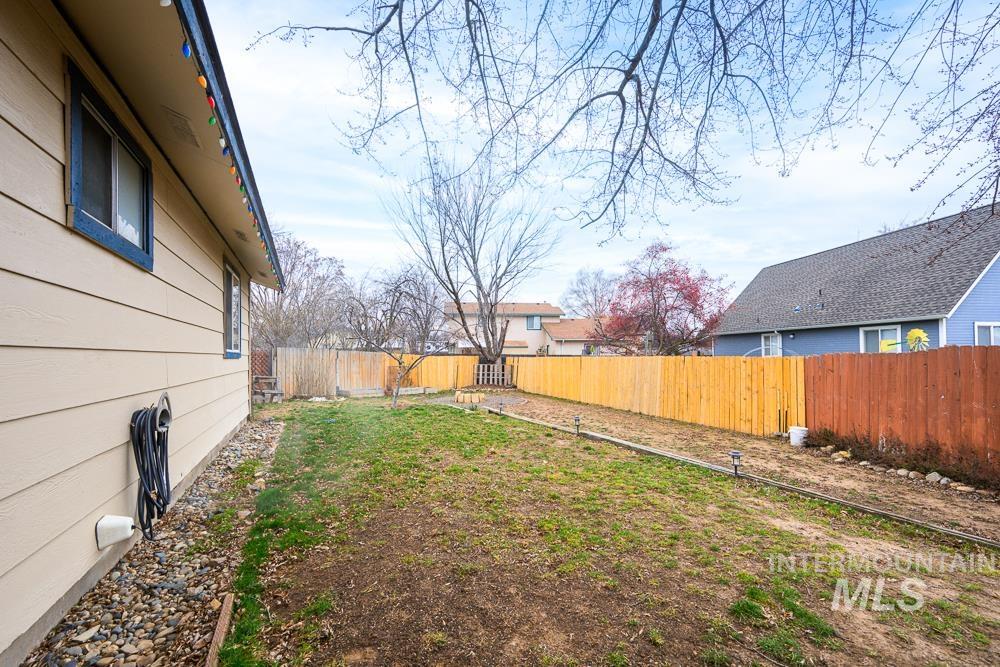 Fenced backyard with a residential view