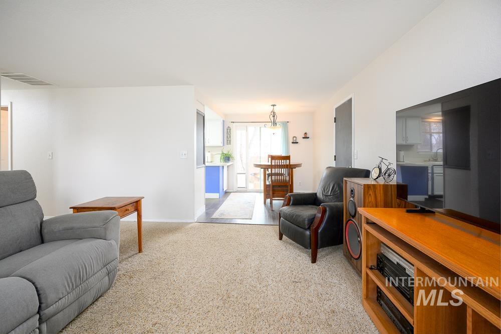 Living room with light carpet and baseboards