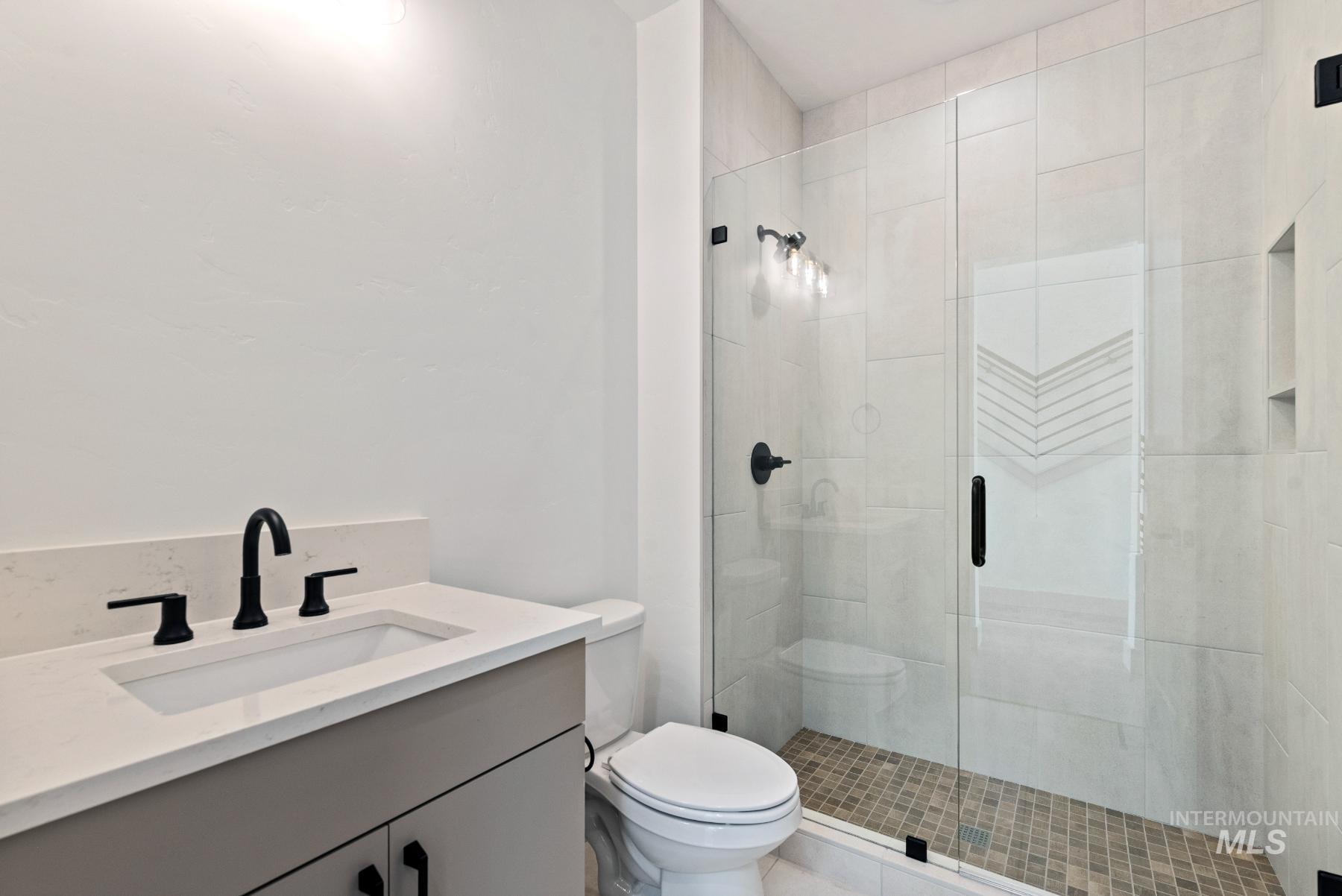 Full bathroom featuring vanity and a stall shower
