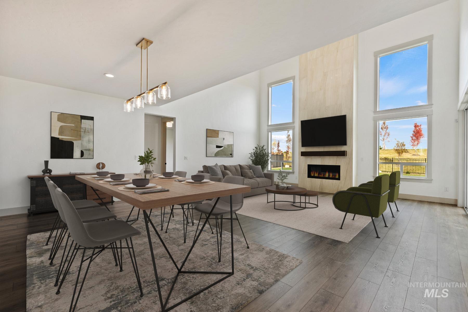Dining space with a fireplace, dark wood-style flooring, and a high ceiling