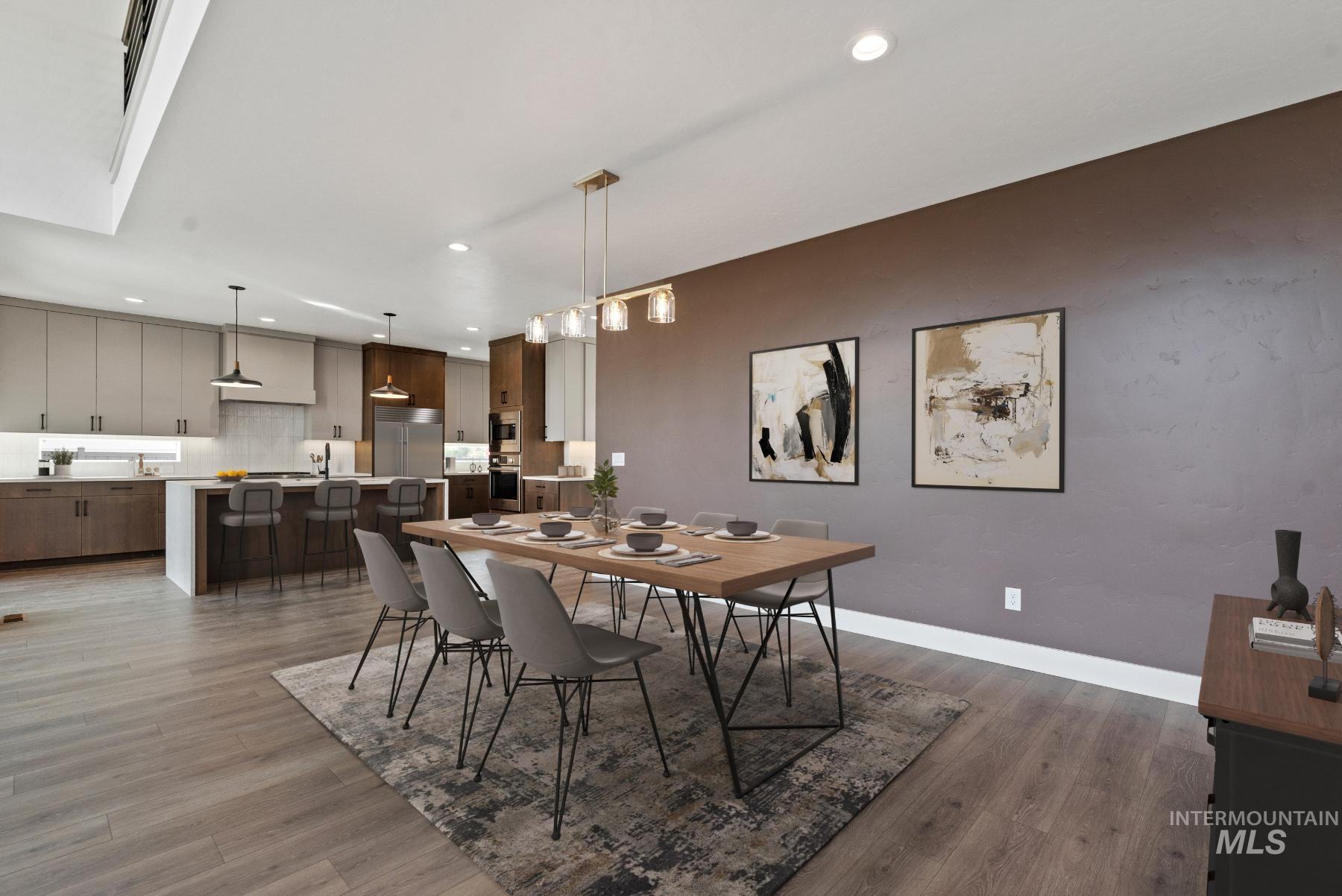 Dining area with light wood-style flooring and recessed lighting
