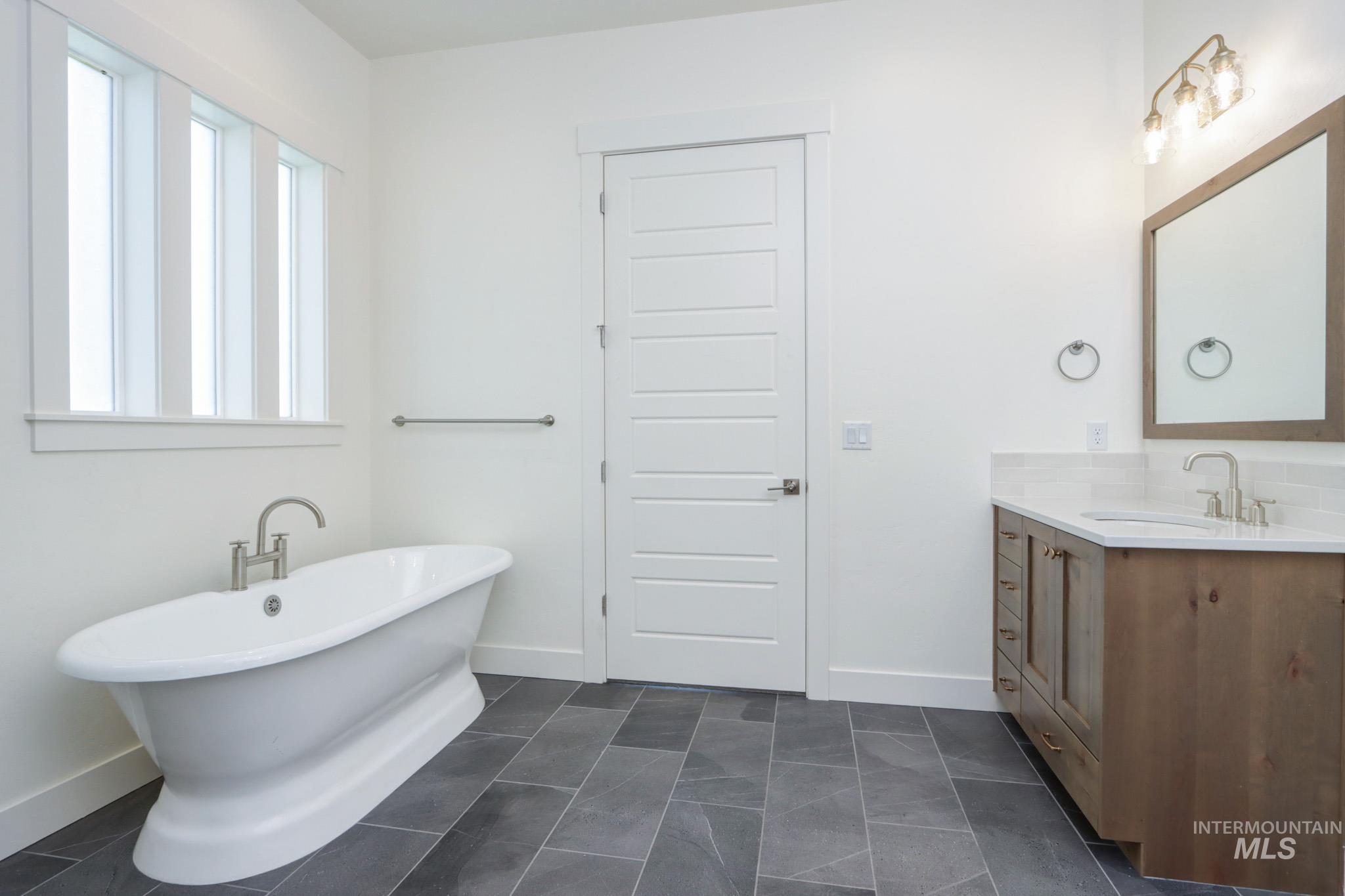 Bathroom featuring a freestanding tub and vanity