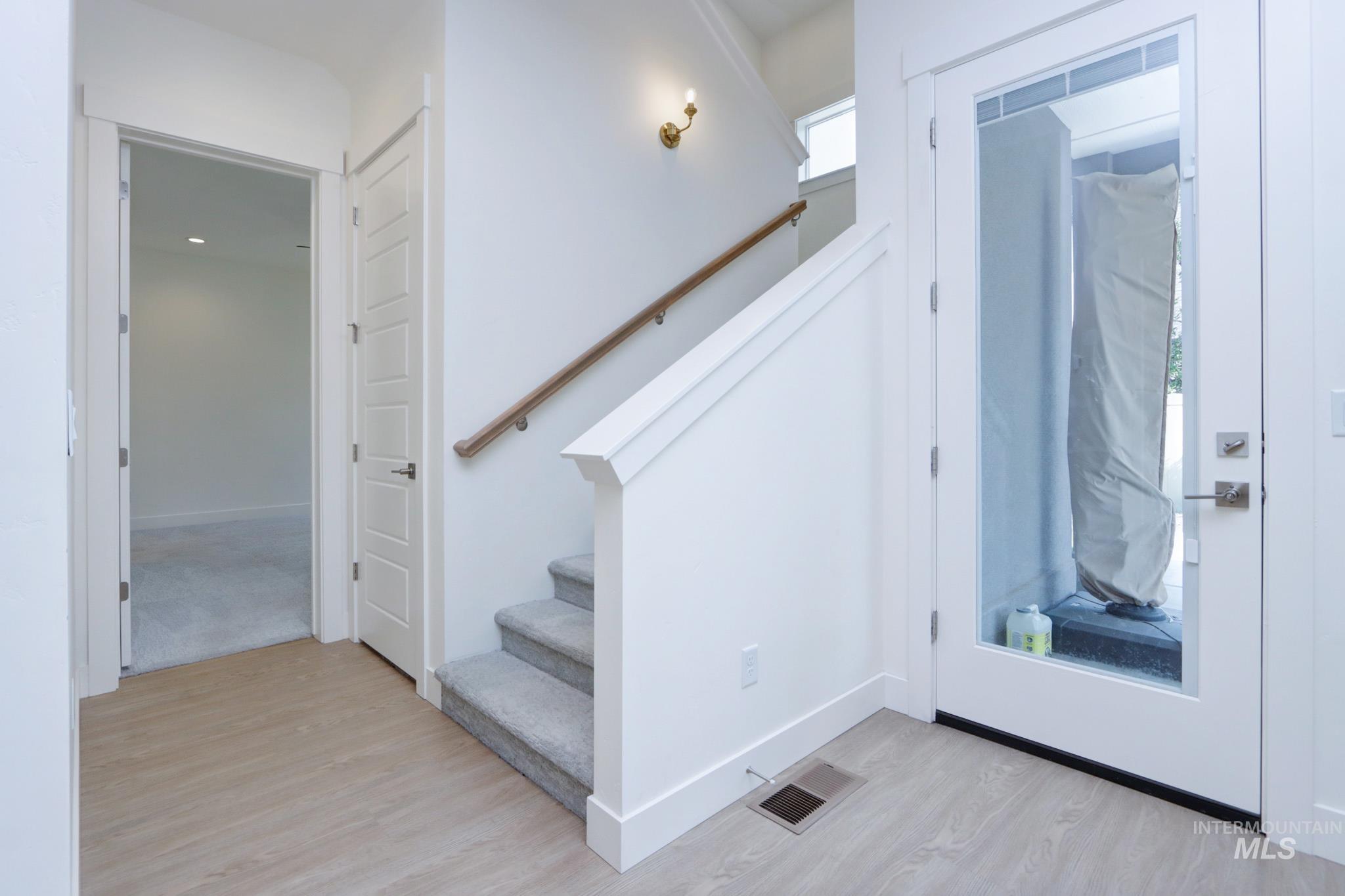 Foyer featuring light wood-style floors and stairs