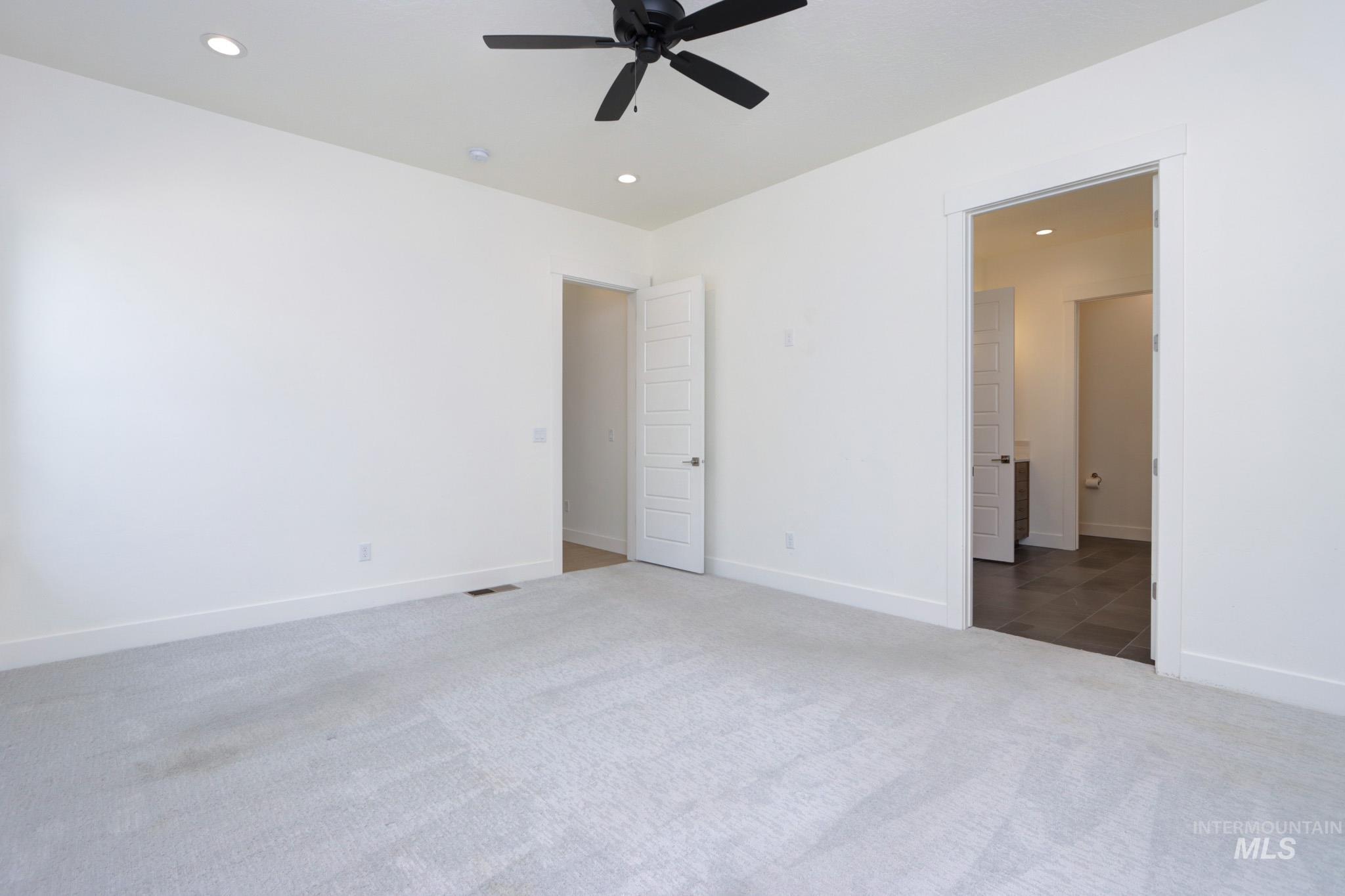 Unfurnished bedroom with recessed lighting, carpet, ensuite bath, and ceiling fan