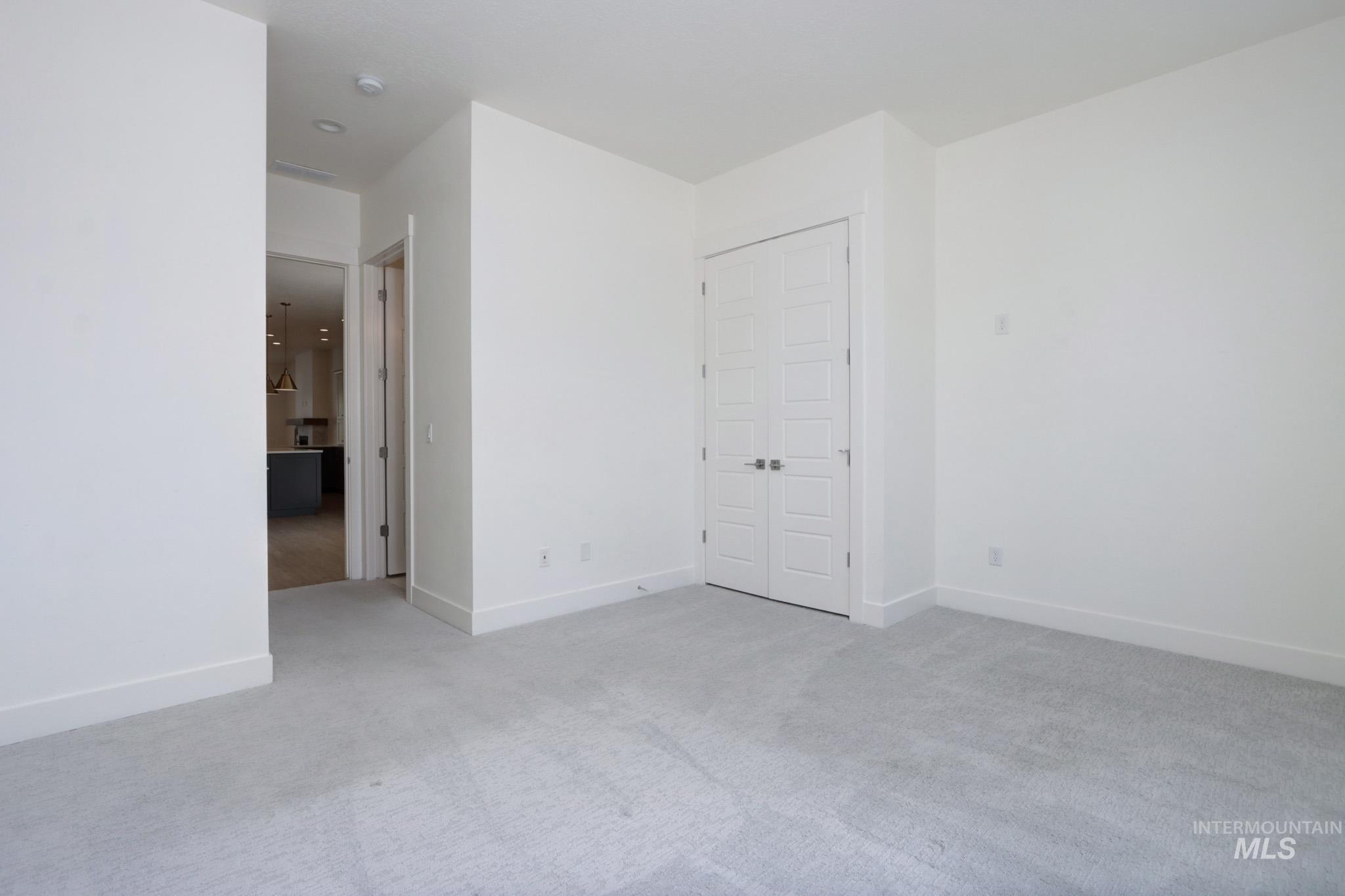 Unfurnished bedroom featuring carpet floors and baseboards