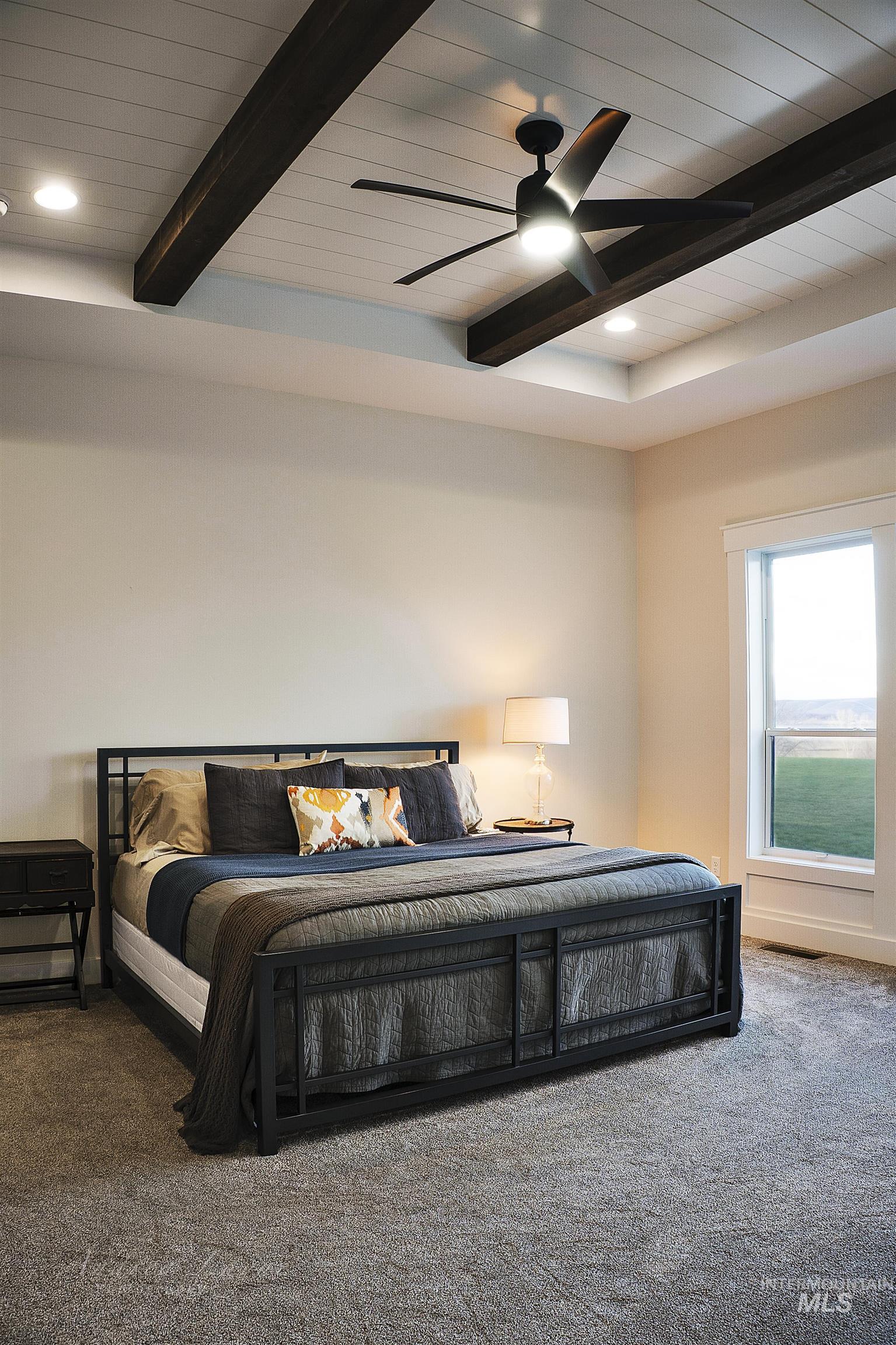 Carpeted bedroom with recessed lighting, ceiling fan, and a wooden ceiling with exposed beams