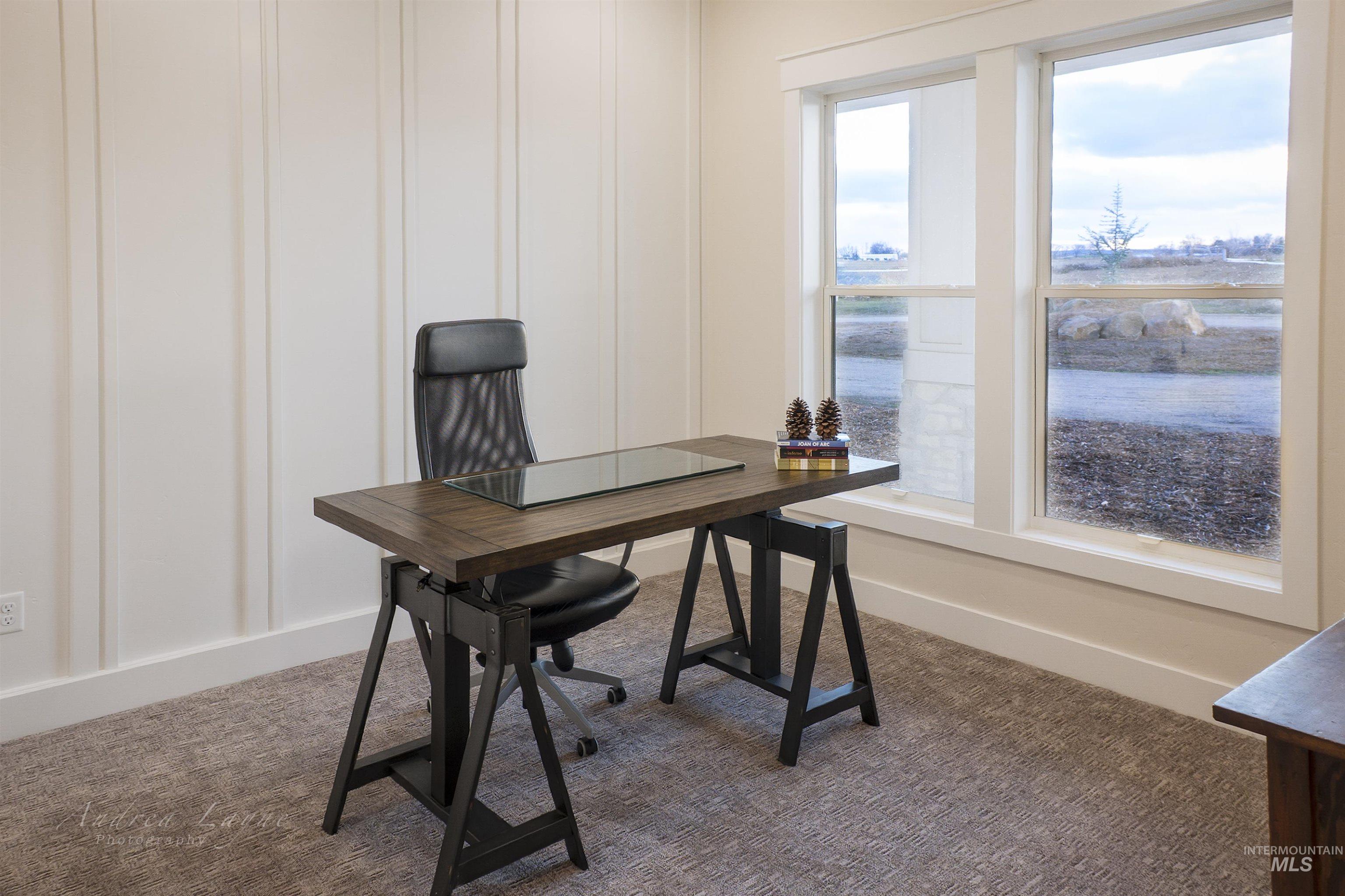 Office space featuring carpet flooring and a decorative wall