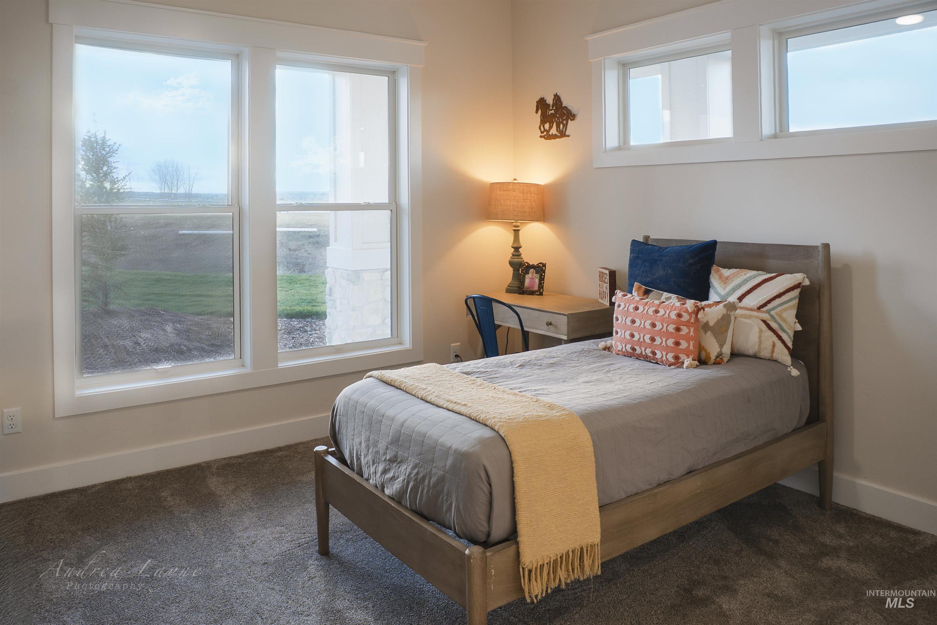Bedroom featuring dark colored carpet