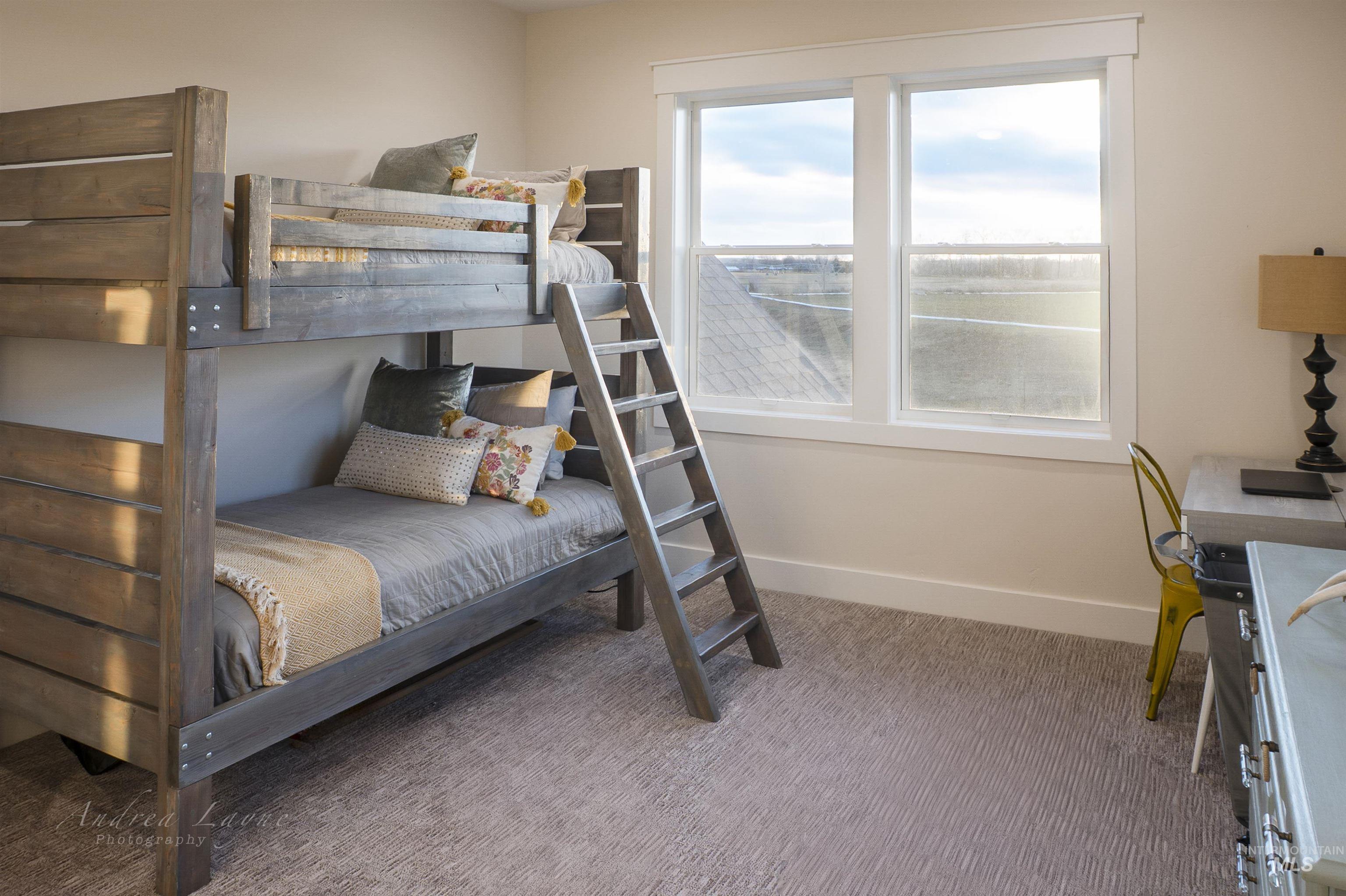 Bedroom with baseboards and light colored carpet