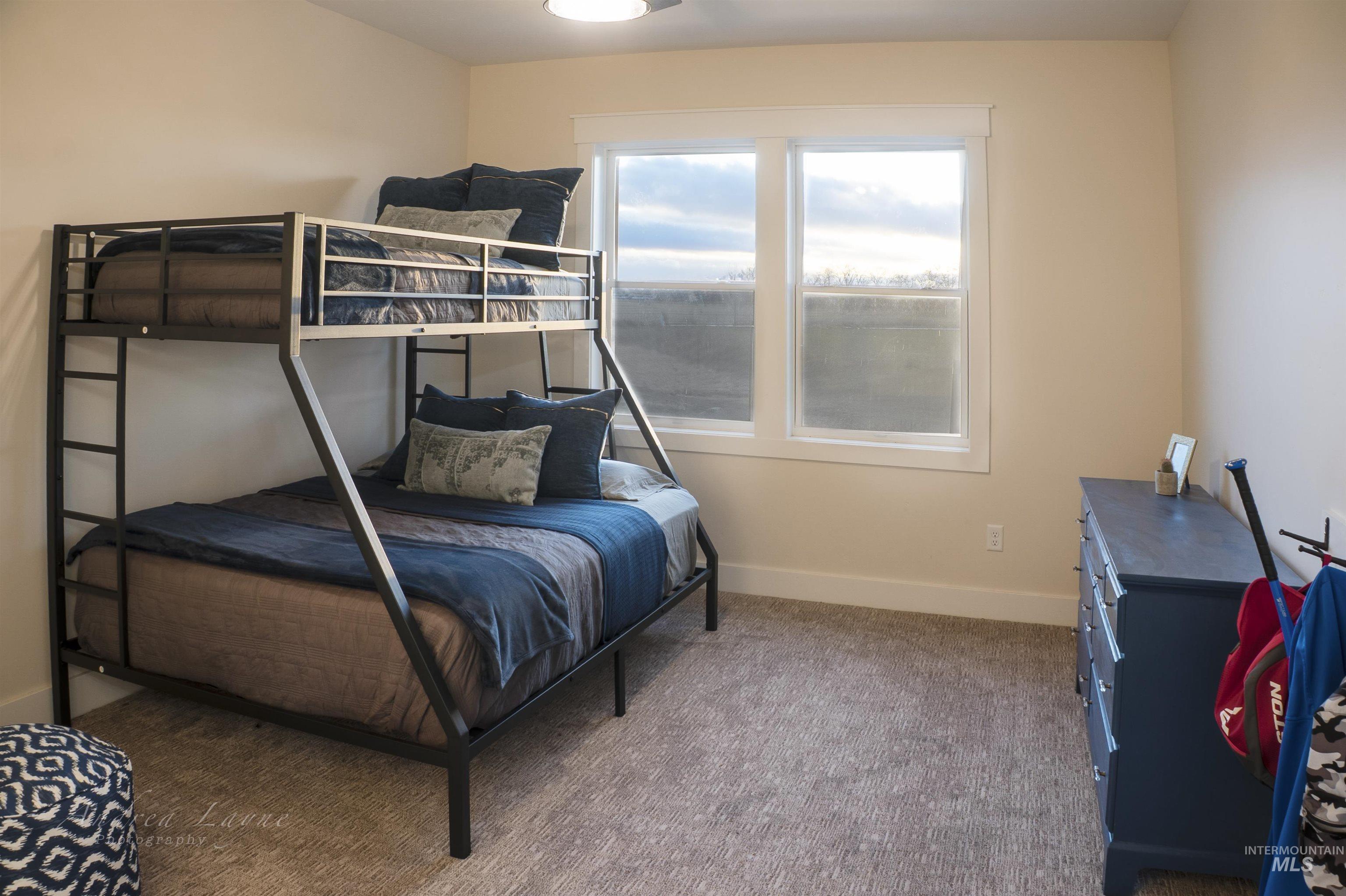 Carpeted bedroom featuring baseboards