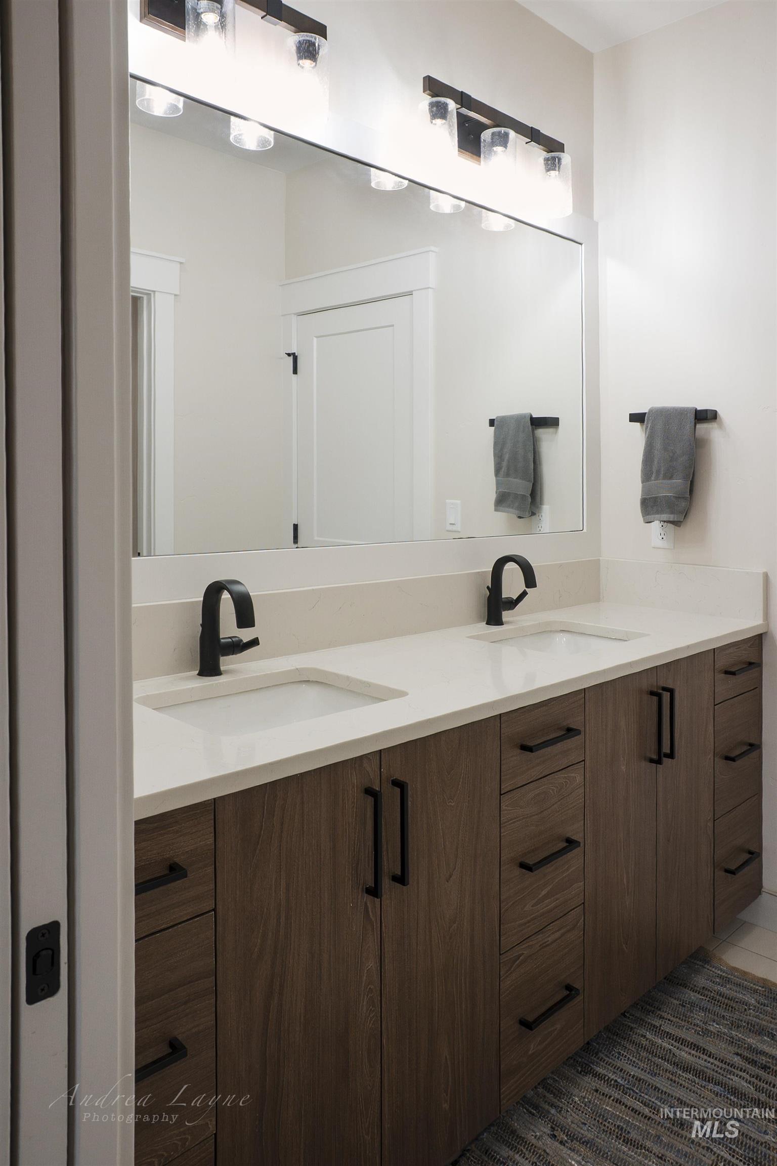 Full bath featuring double vanity