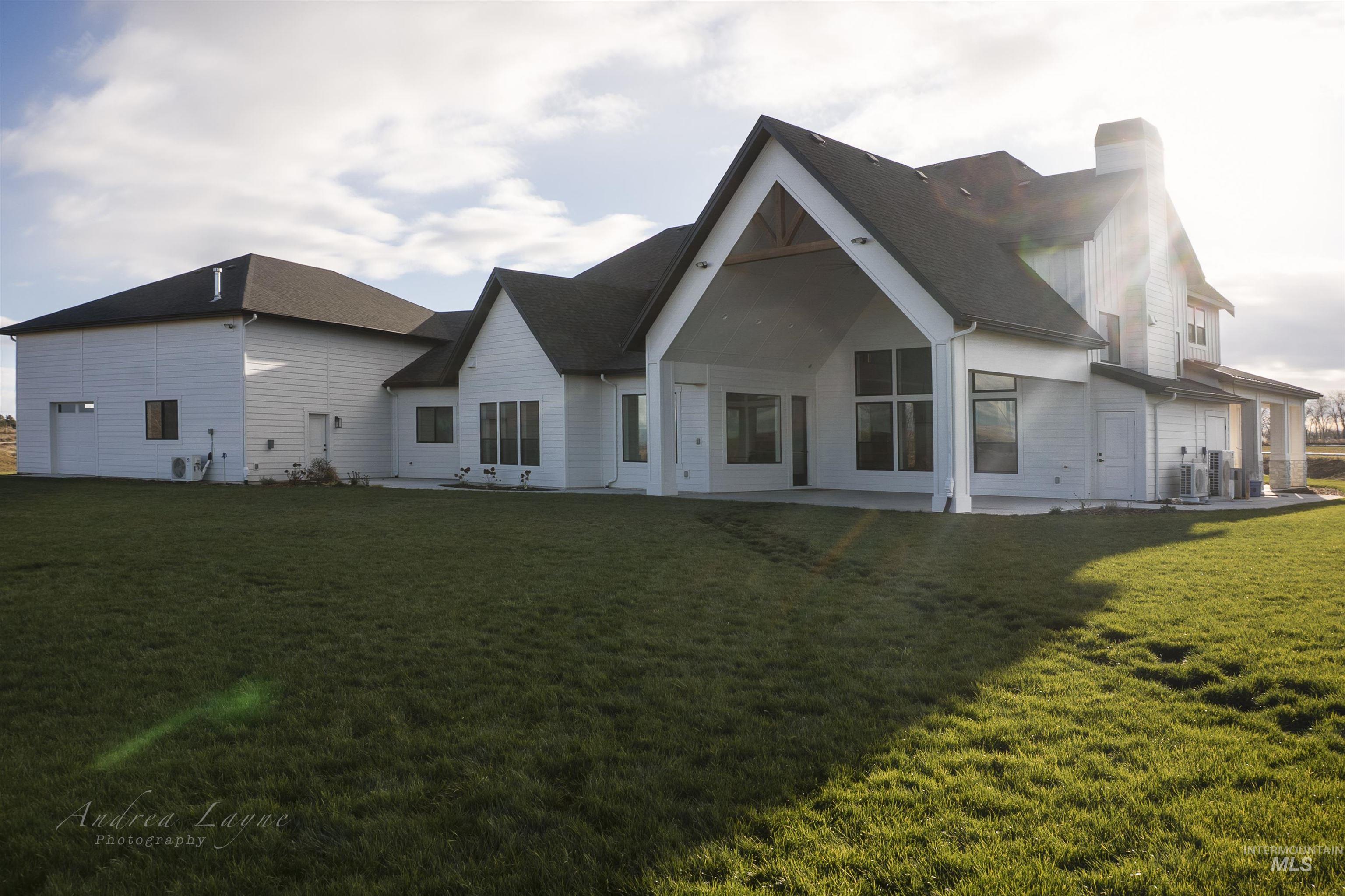 Back of house featuring a patio area, a yard, and a chimney