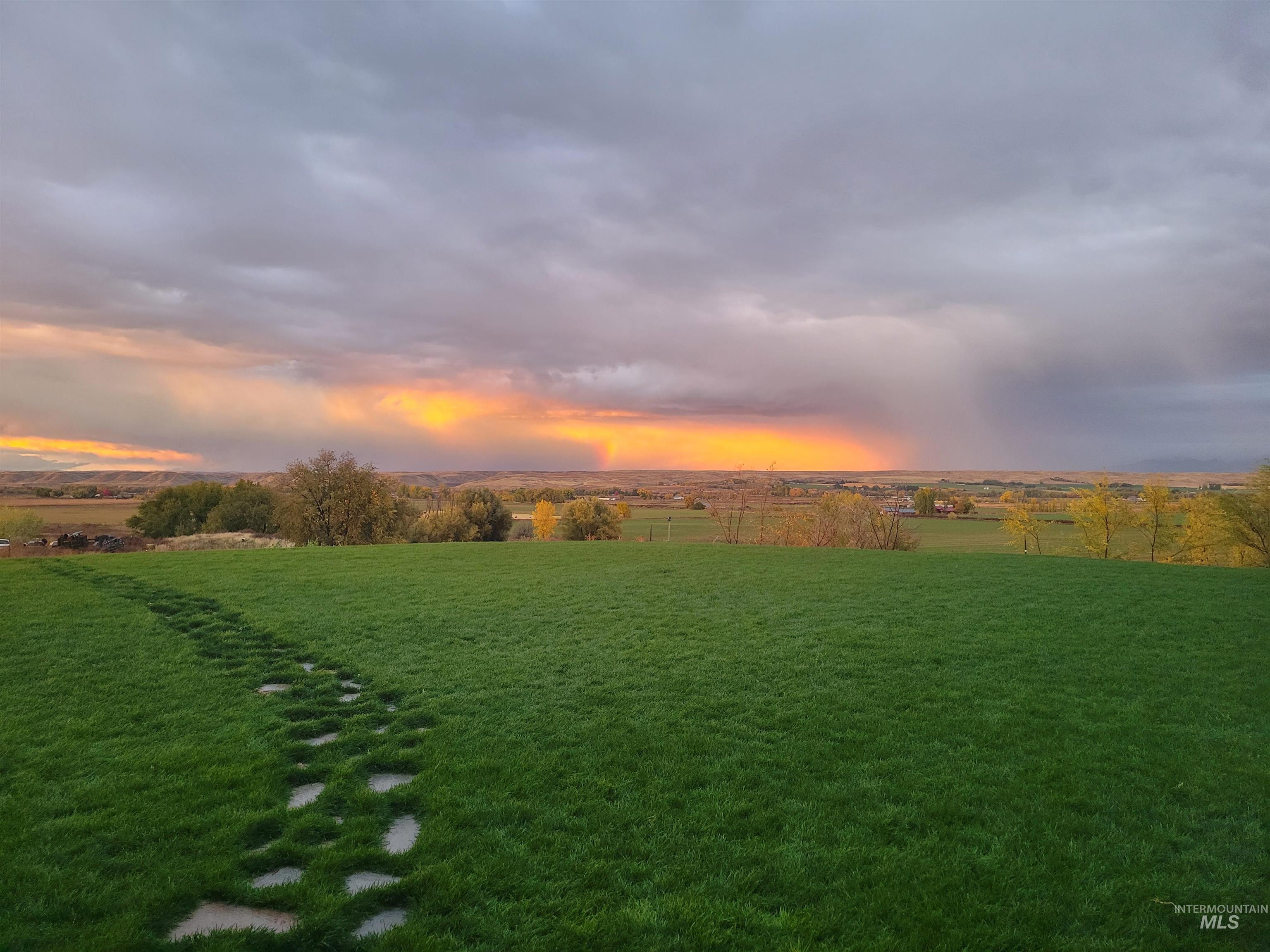 View of green lawn featuring a rural view