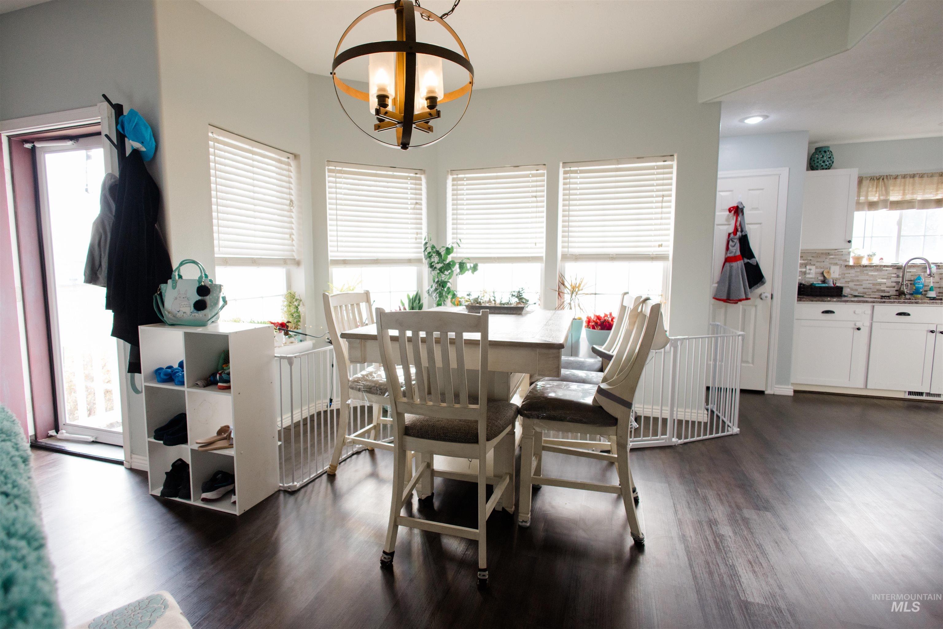 Dining area featuring dark wood finished floors and a chandelier