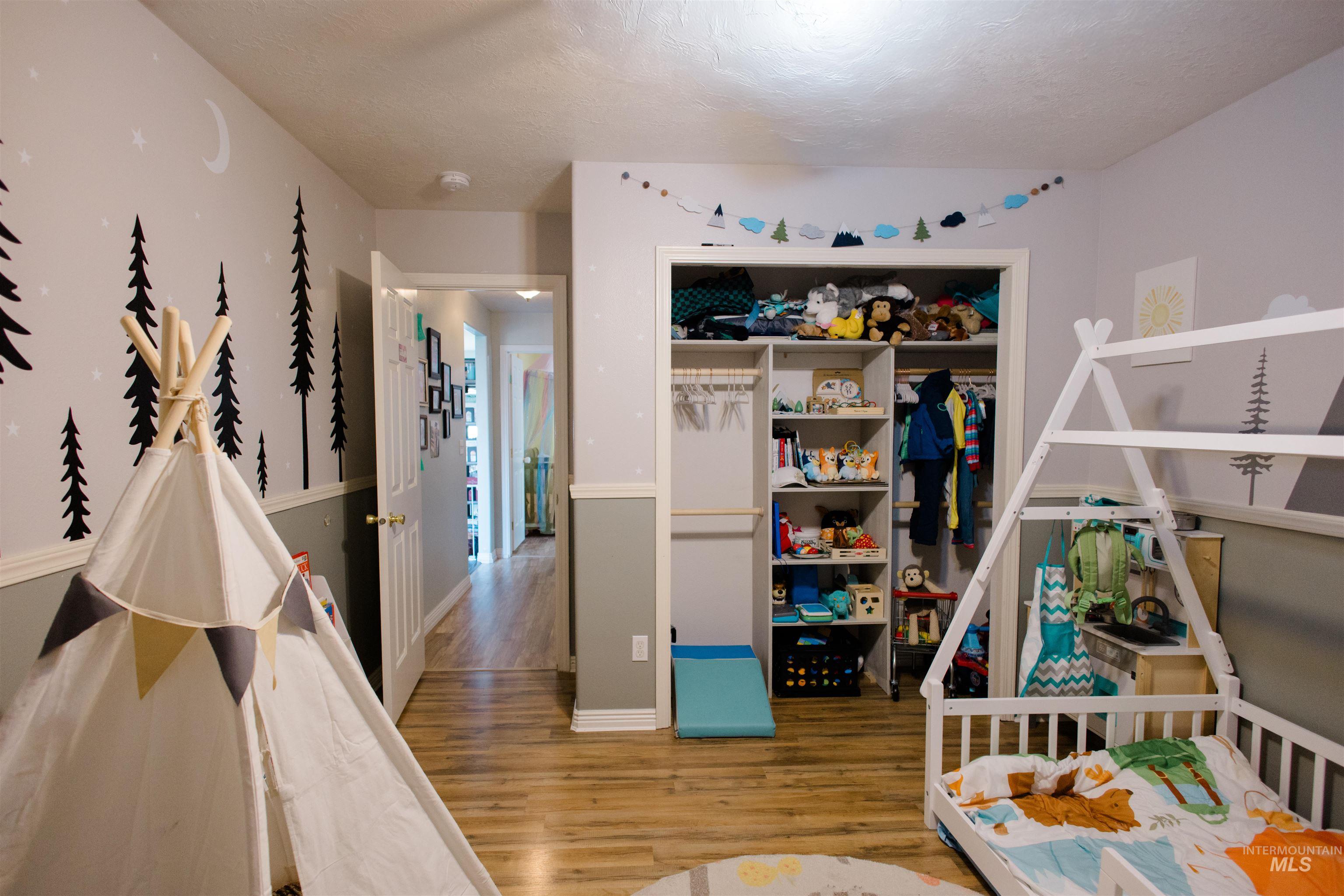 Bedroom featuring light wood-style floors and a closet