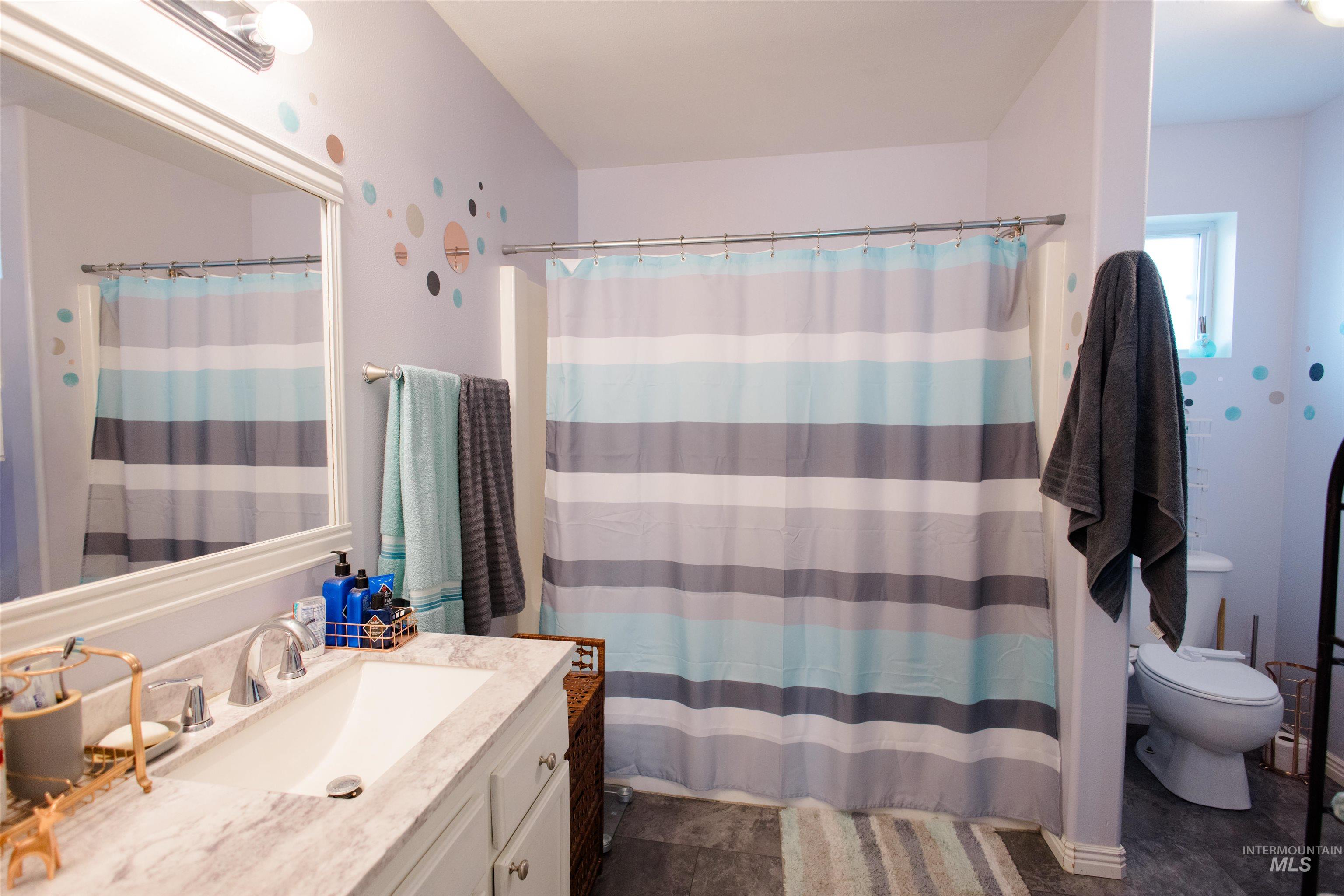Full bath with vanity and a shower with curtain
