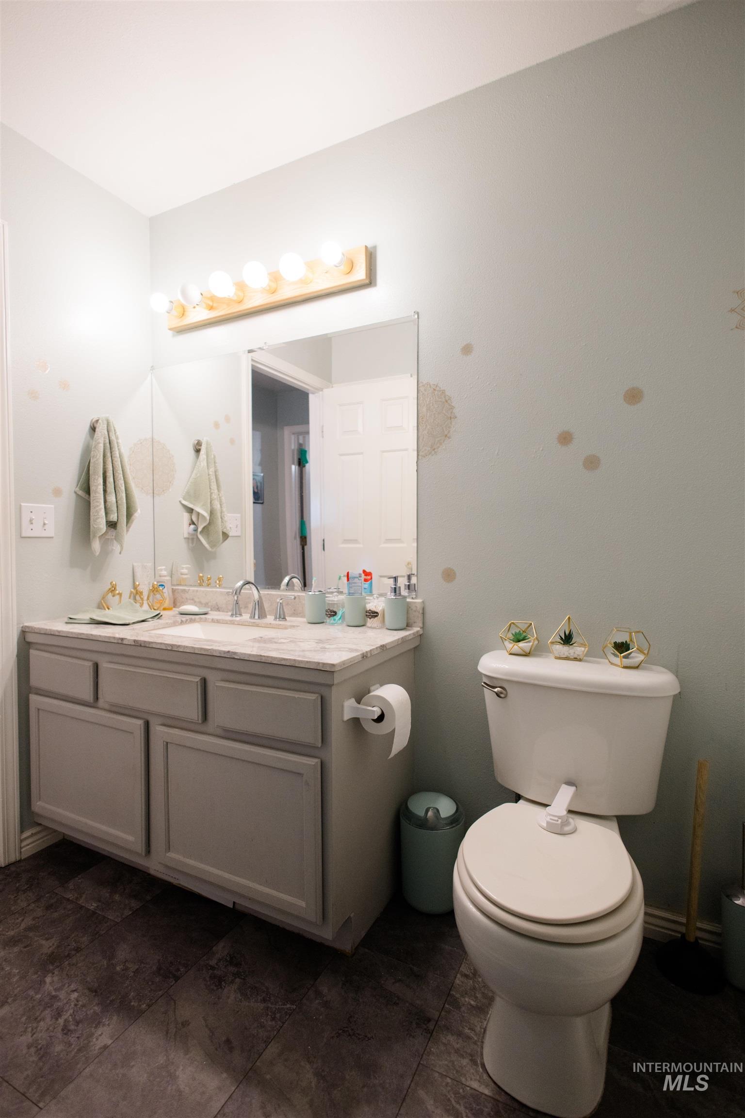 Half bathroom with vanity and toilet