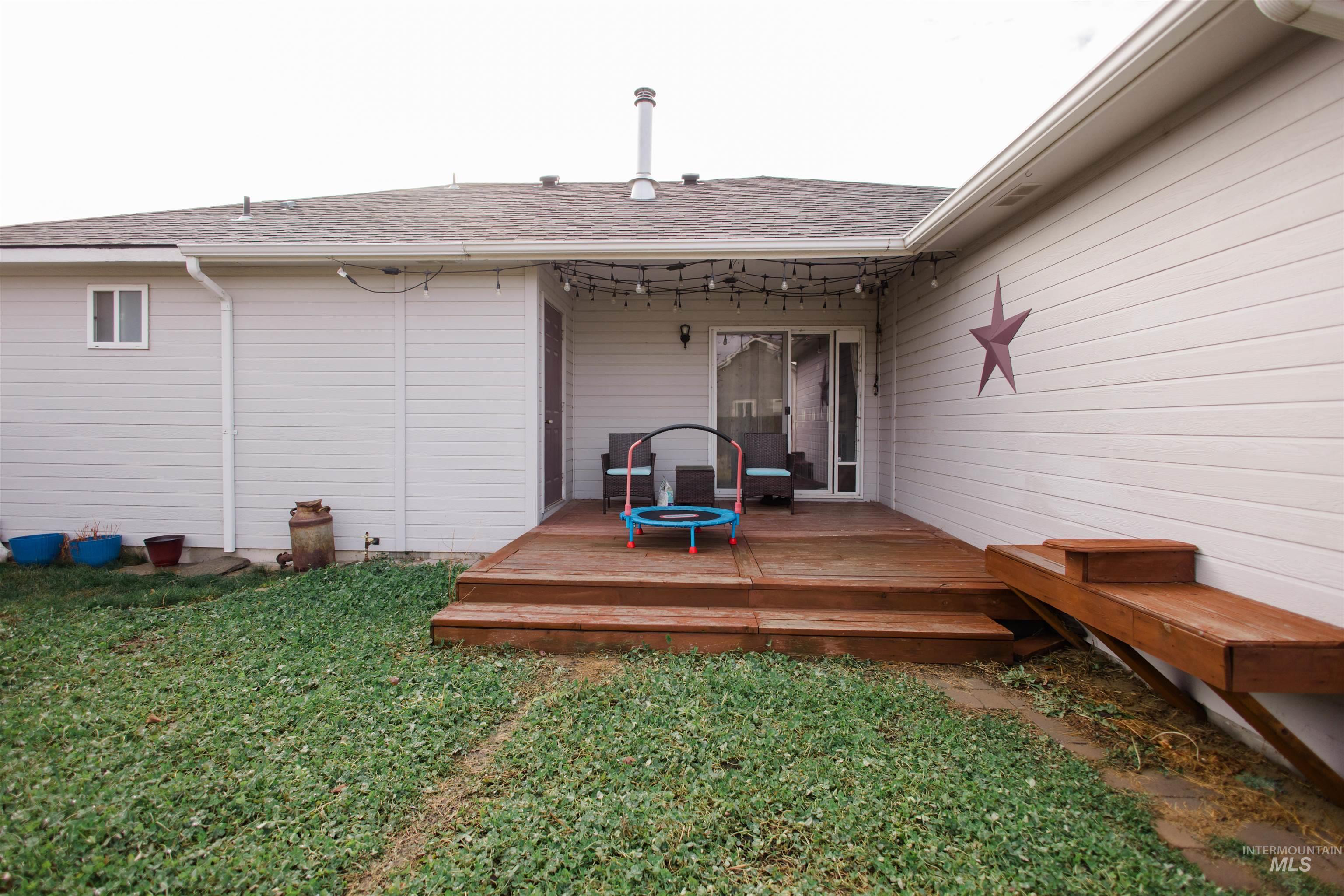 Wooden terrace featuring a yard