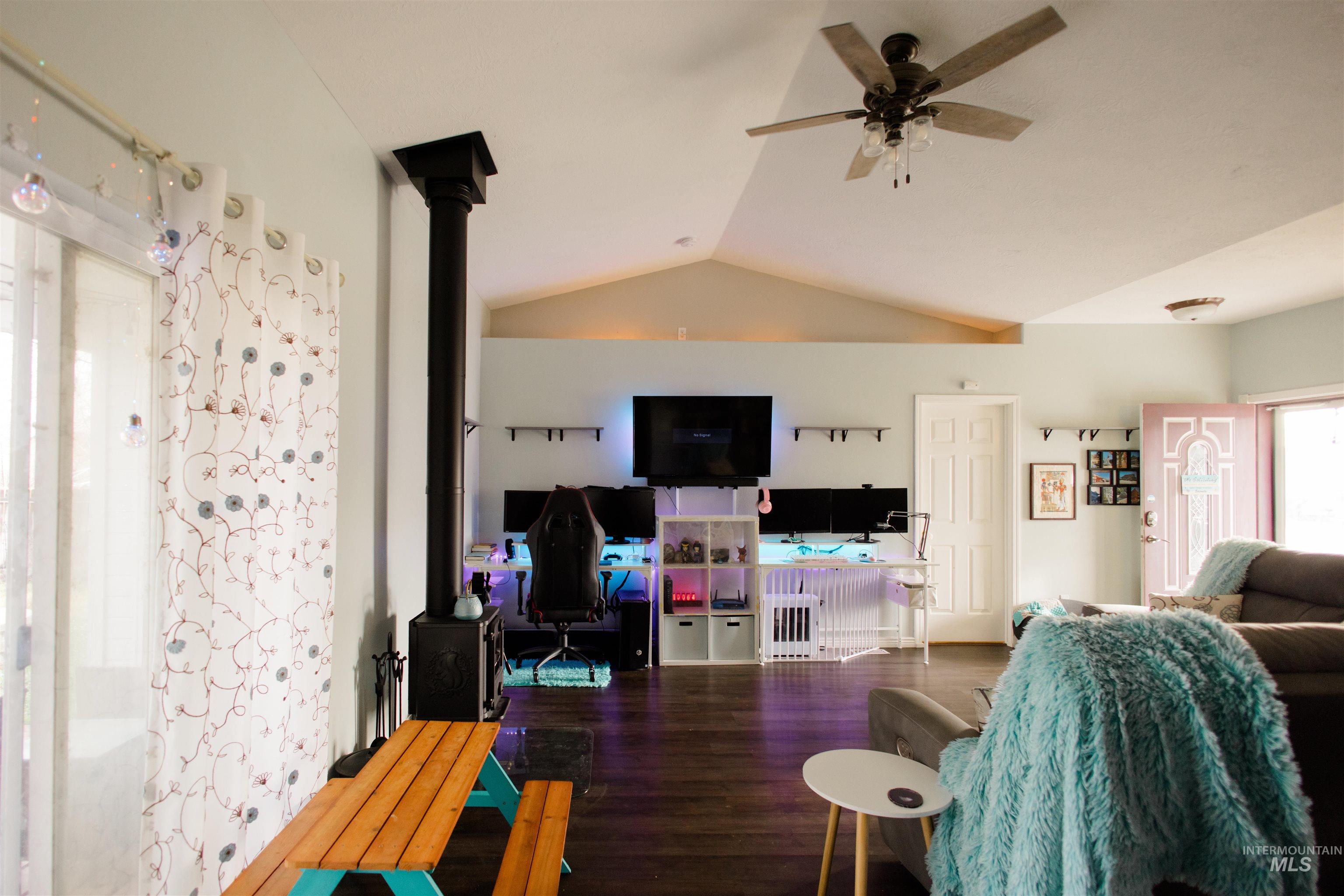 Living room featuring vaulted ceiling and wood finished floors
