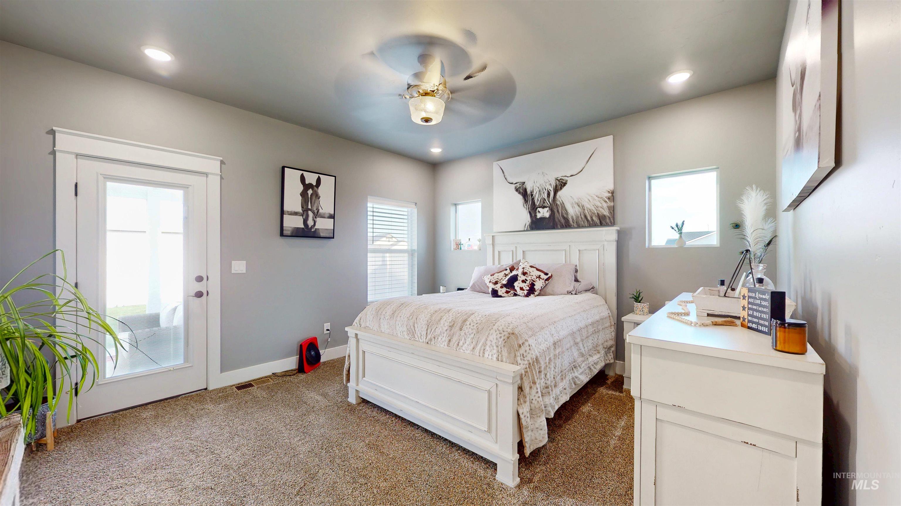 Bedroom with multiple windows, carpet flooring, a ceiling fan, recessed lighting, and access to outside