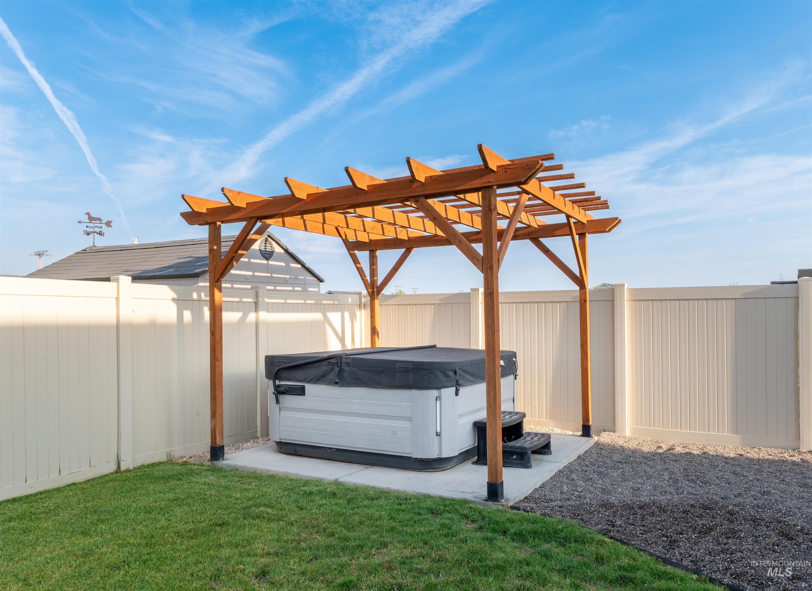 View of parking / parking lot with a fenced backyard