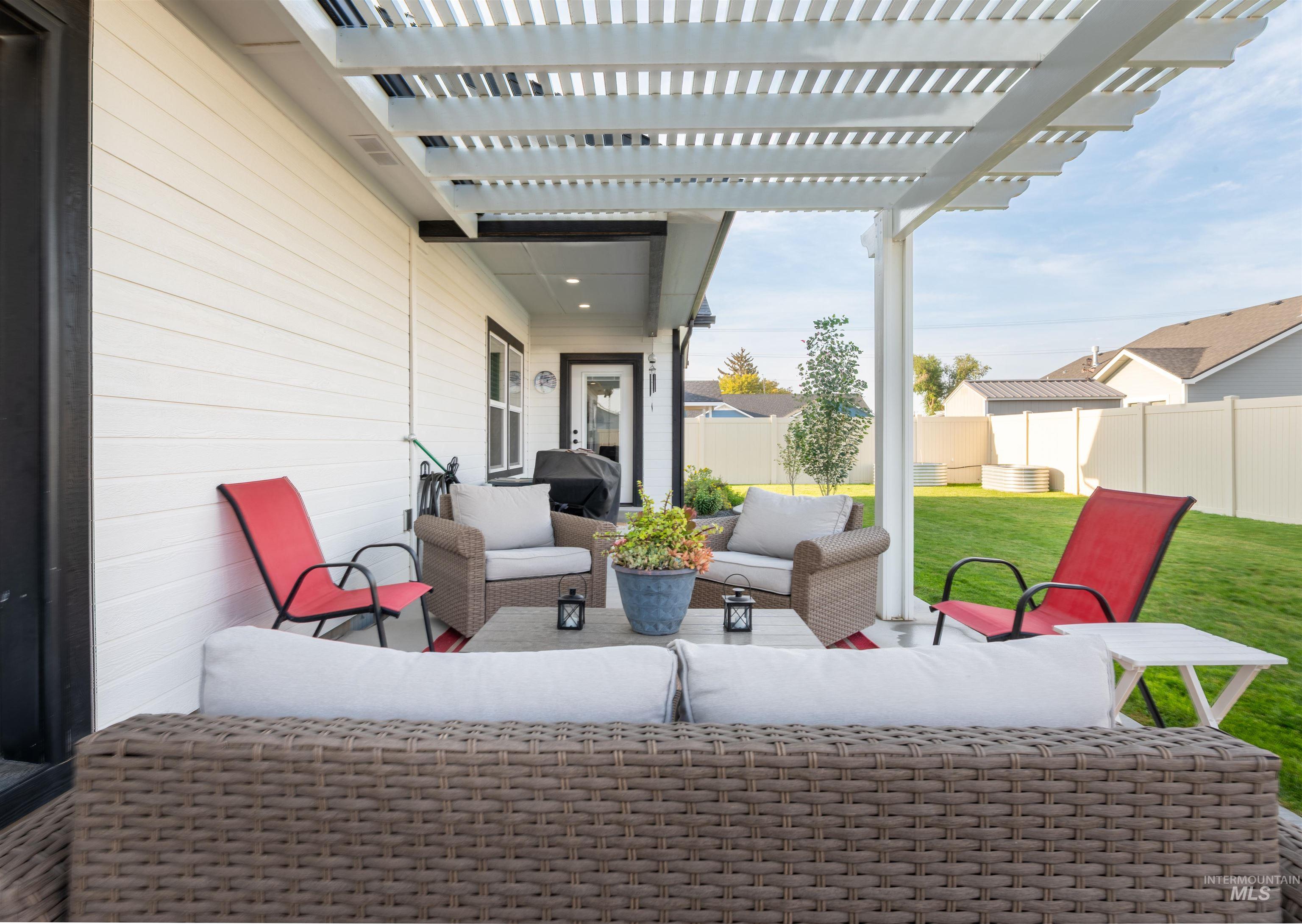 View of patio / terrace with a pergola, an outdoor living space, and a grill