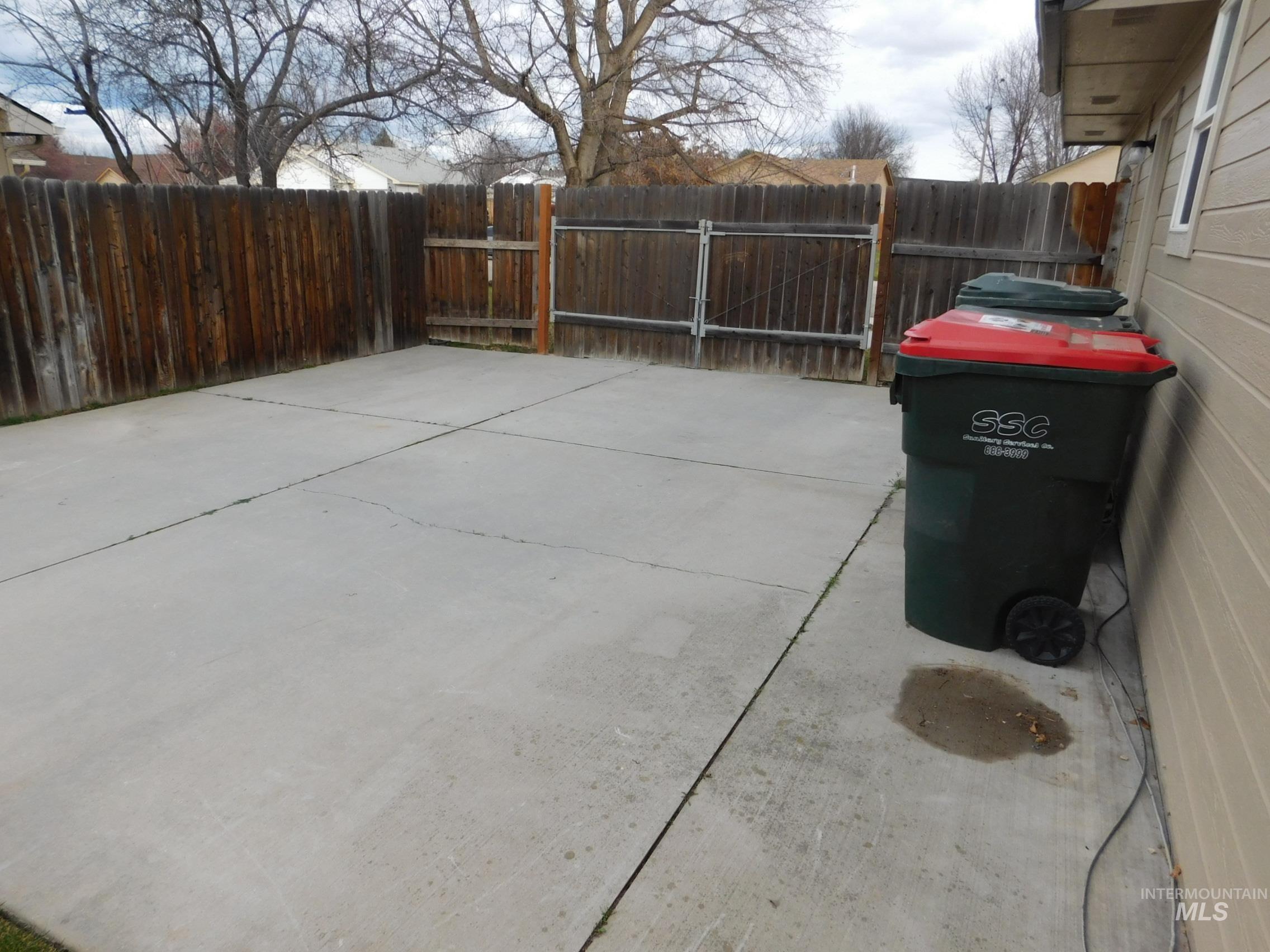 Fenced backyard featuring a patio