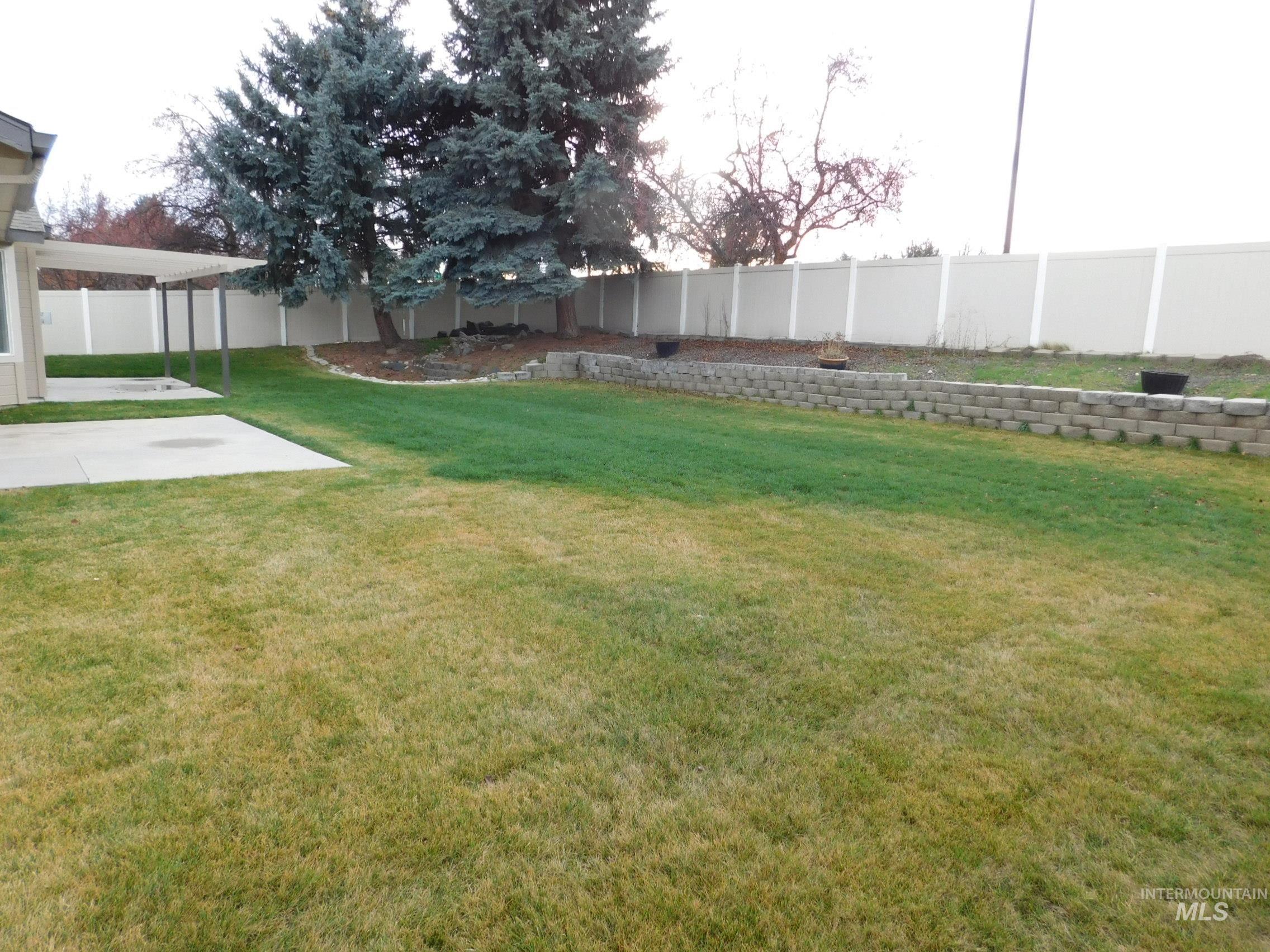 Fenced backyard with a patio