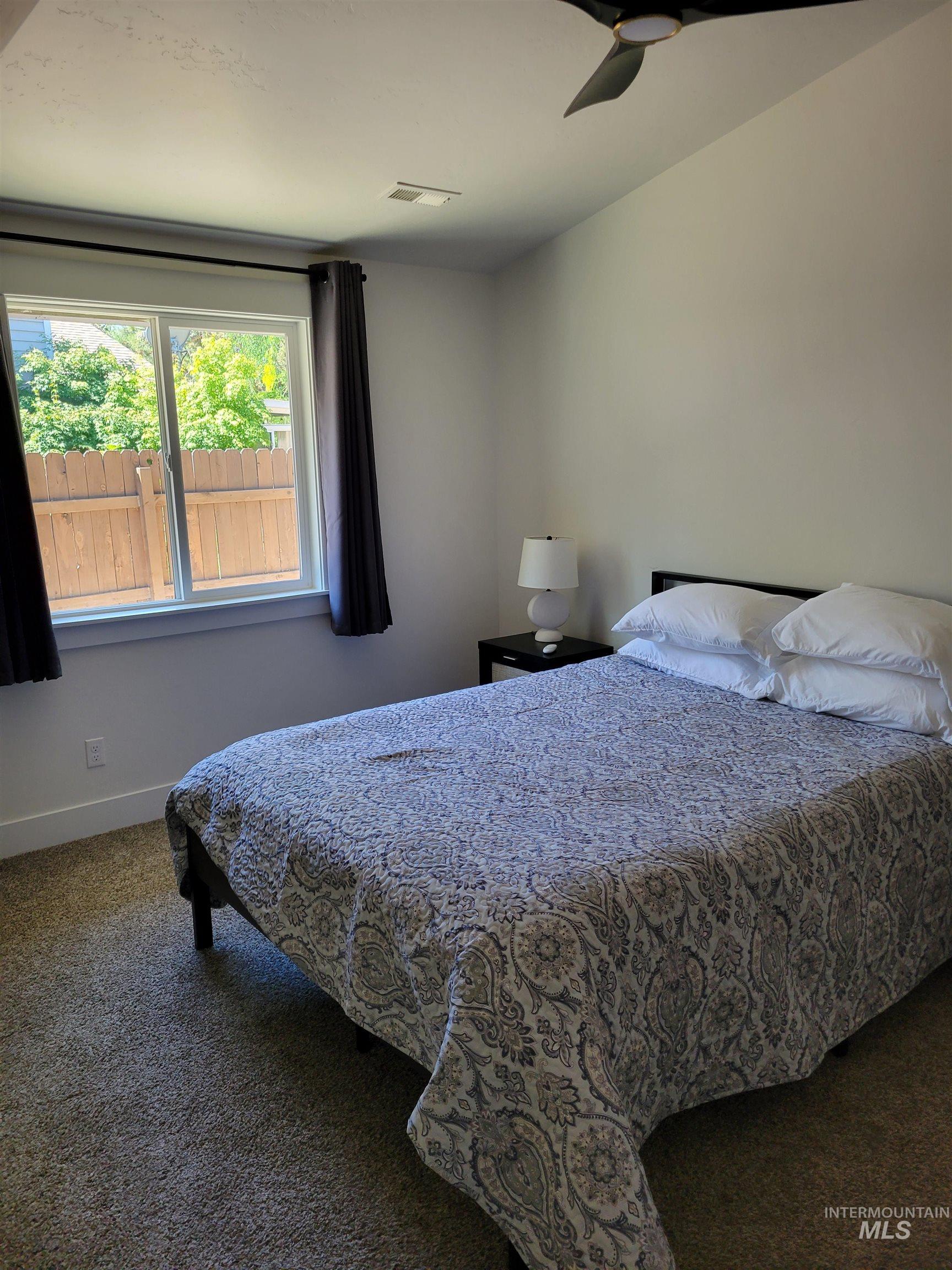 Carpeted bedroom with baseboards